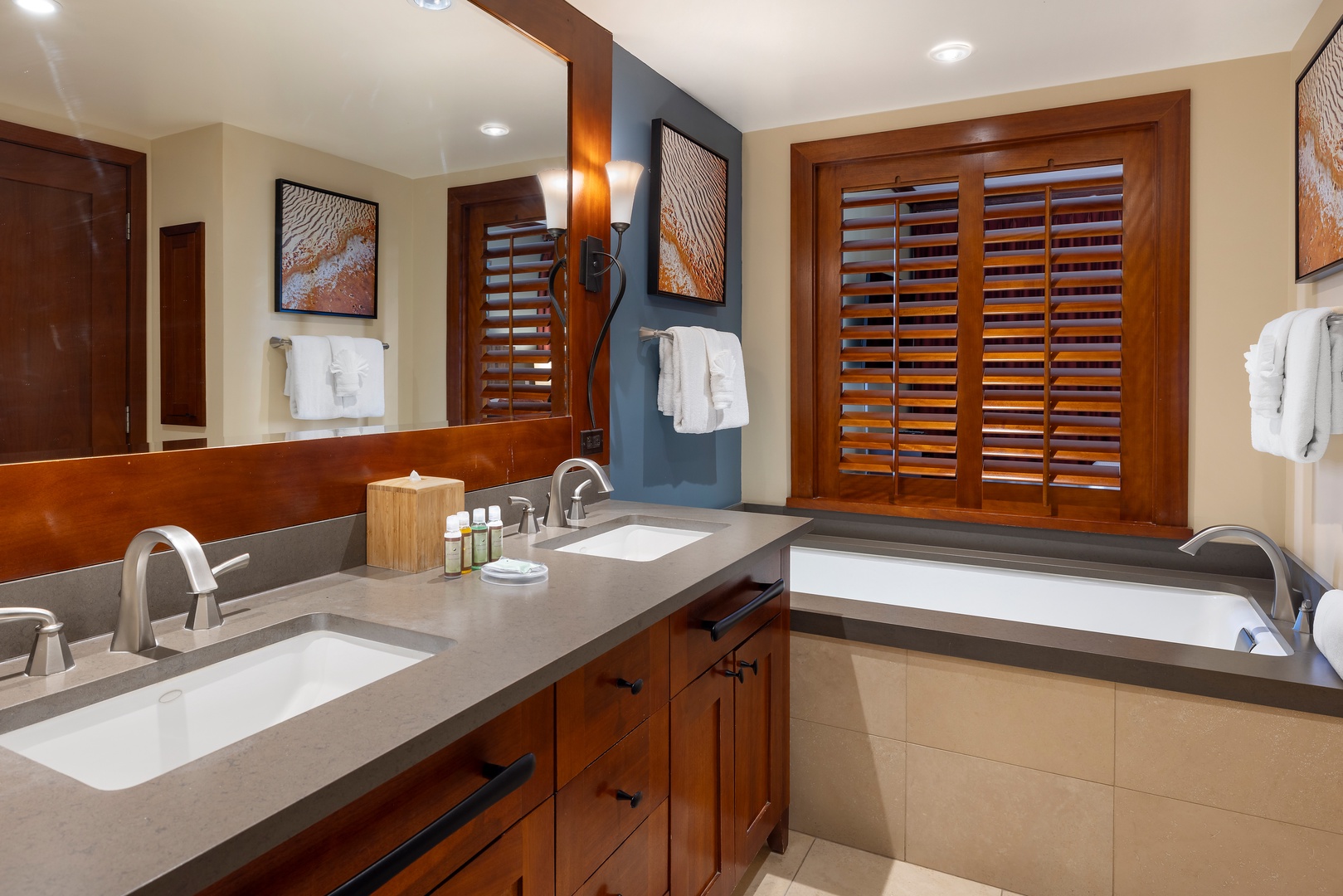 Unwind in your spacious bathroom with dual vanities, soaking tub, and elegant wood finishes creating a spa-like retreat.
