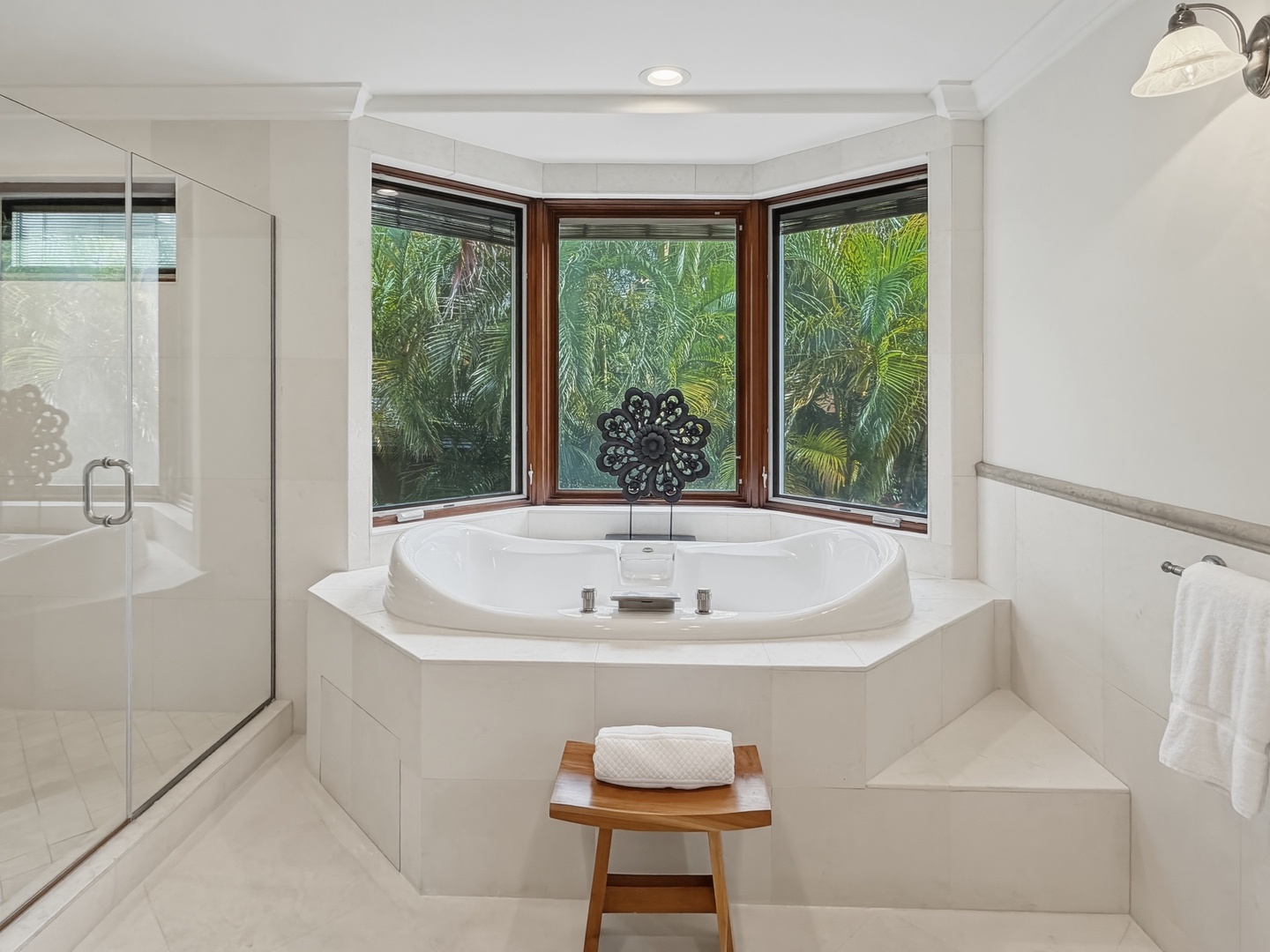 Honolulu Vacation Rentals, Maunalua Estate - Luxurious soaking tub surrounded by tropical palms, where relaxation meets paradise through panoramic windows.