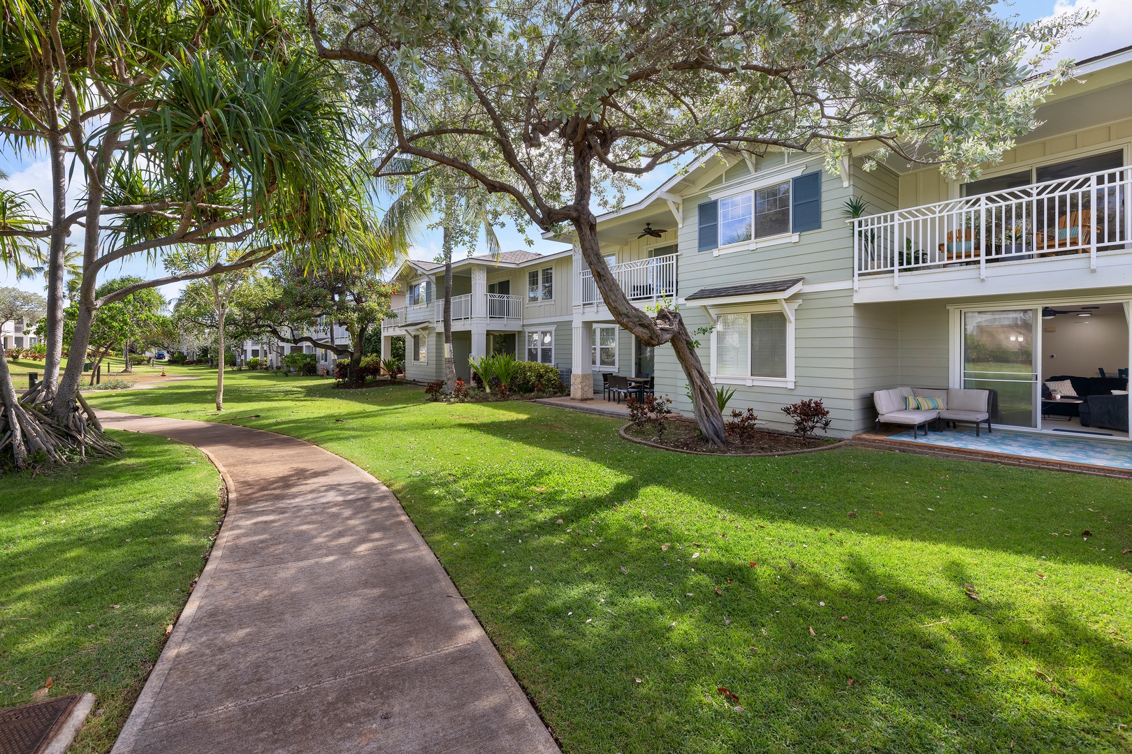 Peaceful garden pathways wind through the lush tropical landscaping surrounding the Ko Olina Kai residences.