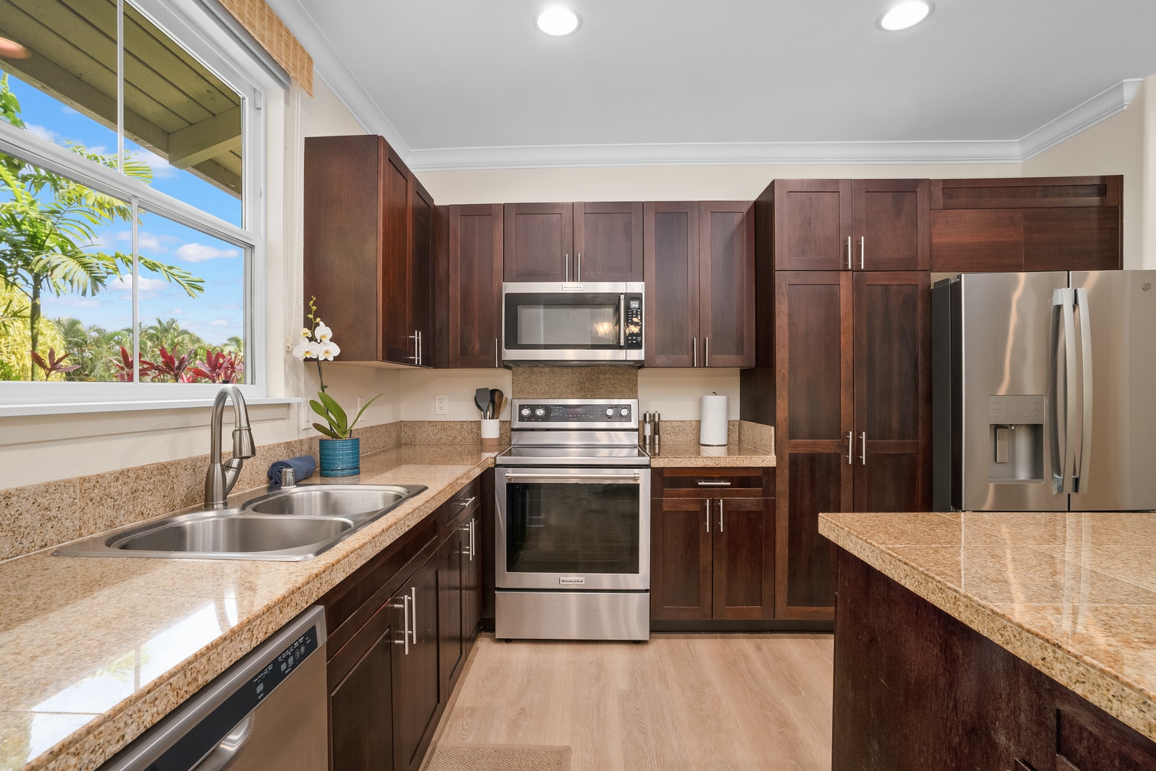 Princeville Vacation Rentals, Hale Kaua'i - Cook comfortably with full-size appliances and bright windows overlooking tropical greenery.