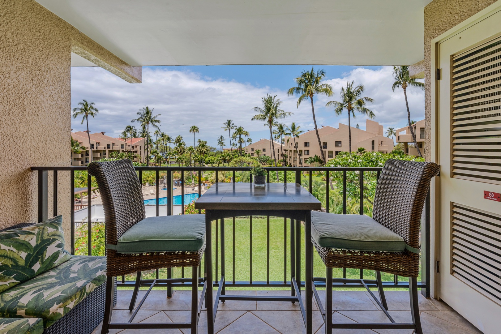 Kihei Vacation Rentals, Kamaole Sands 5310 - Coffee for two on the lanai, palm trees and the grounds stretching out below.