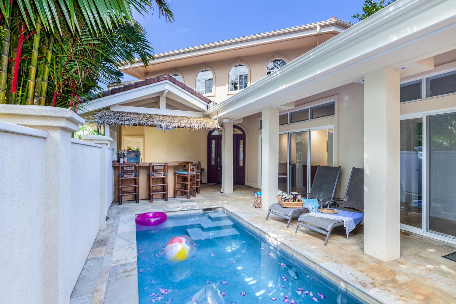 Princeville Vacation Rentals, Ohana Kamalani - Tropical courtyard with poolside seating and tiki bar for ultimate outdoor relaxation.