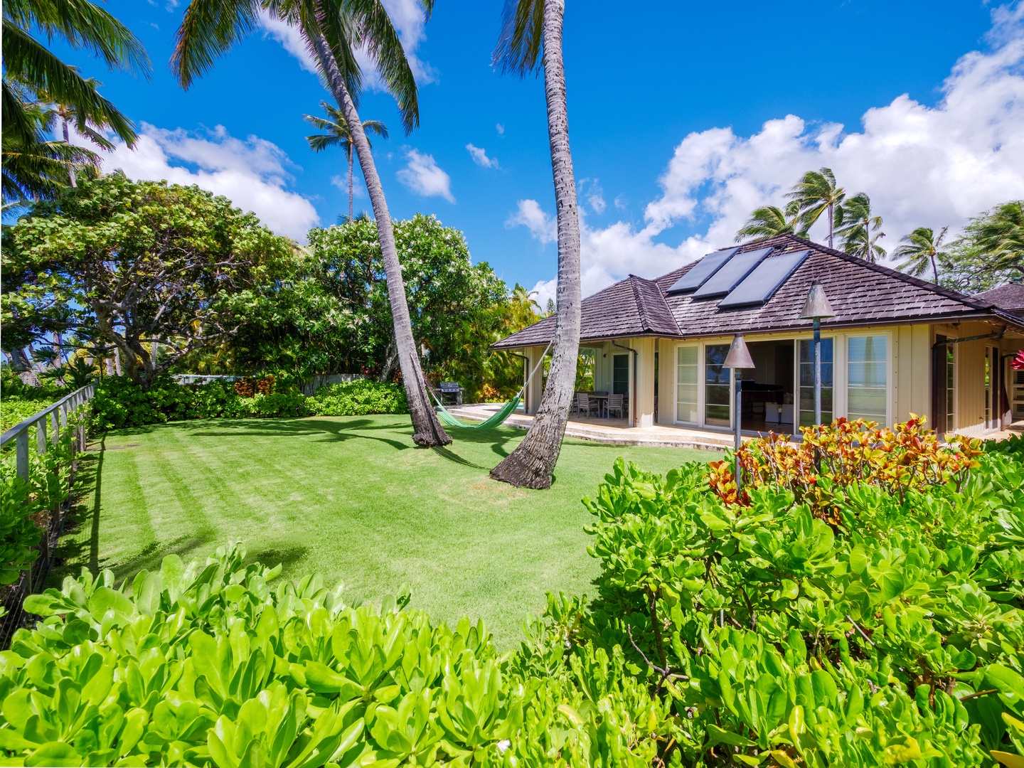Honolulu Vacation Rentals, Paradise Beach Estate - Stroll through the verdant garden, a haven of serenity where nature's beauty unfolds with every step.