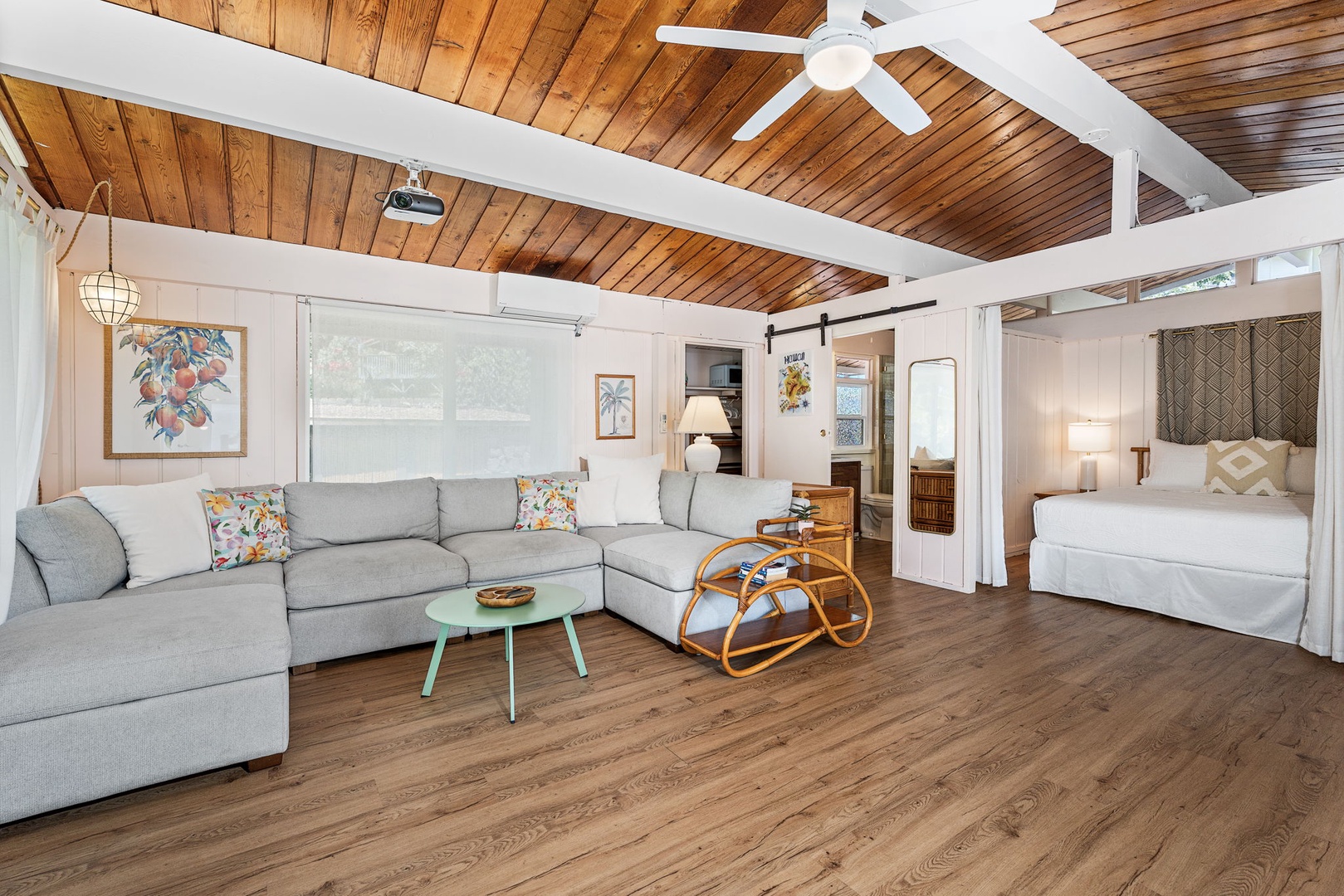 Kailua Kona Vacation Rentals, Mai Tai Manor - Unwind in your cozy open-plan Ohana with vaulted wood ceilings, plush sectional seating, and charming tropical touches.