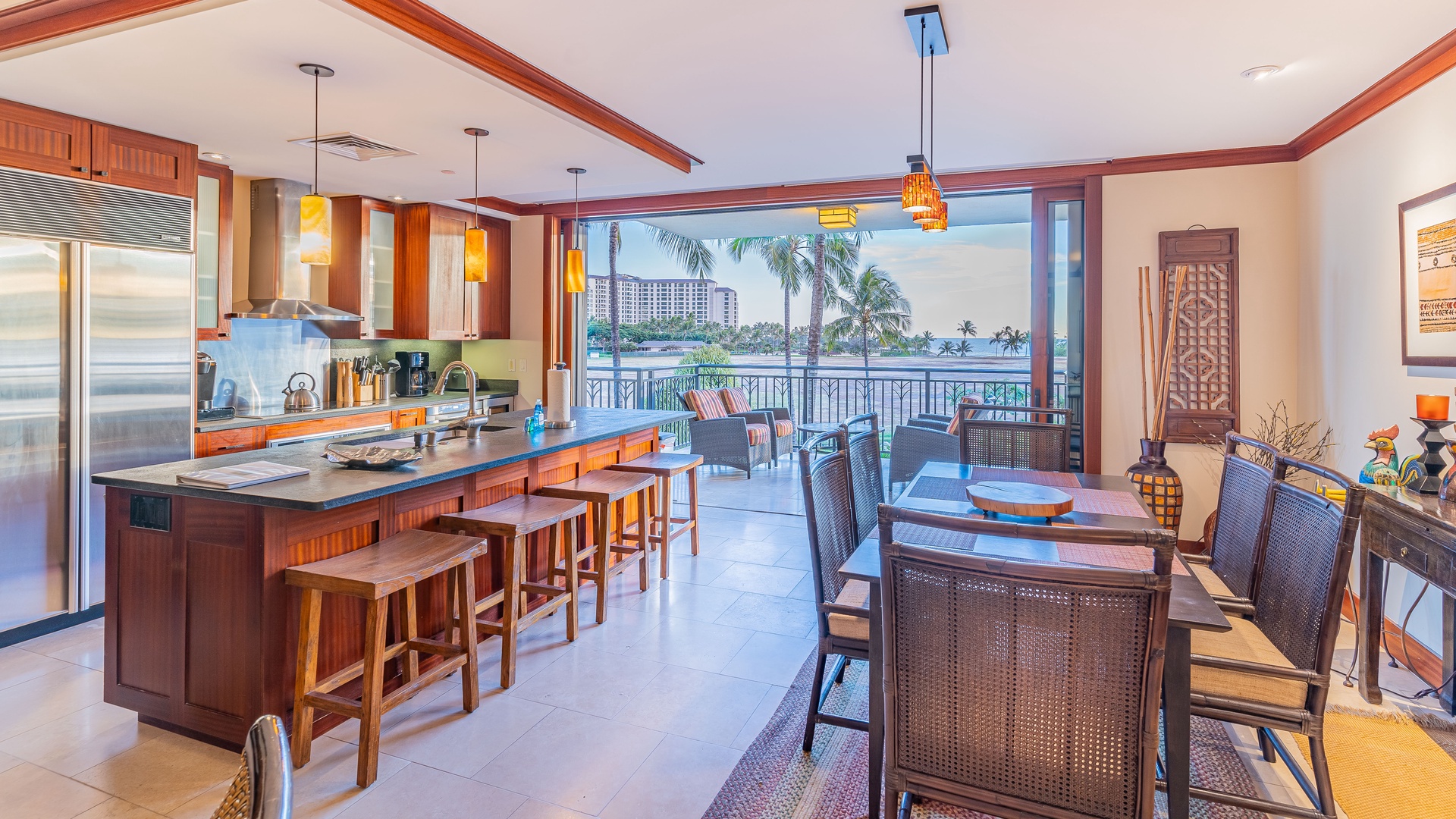 Kapolei Vacation Rentals, Ko Olina Beach Villas B301 - An open floor plan of the kitchen with bar seating and the dining area.