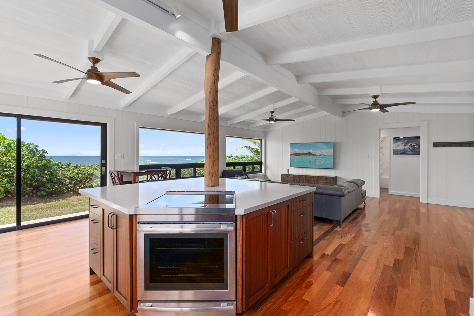 Waialua Vacation Rentals, Mokuleia Beach Villa** - Enjoy seamless flow from the kitchen to the living area, perfect for gathering while taking in the ocean views.