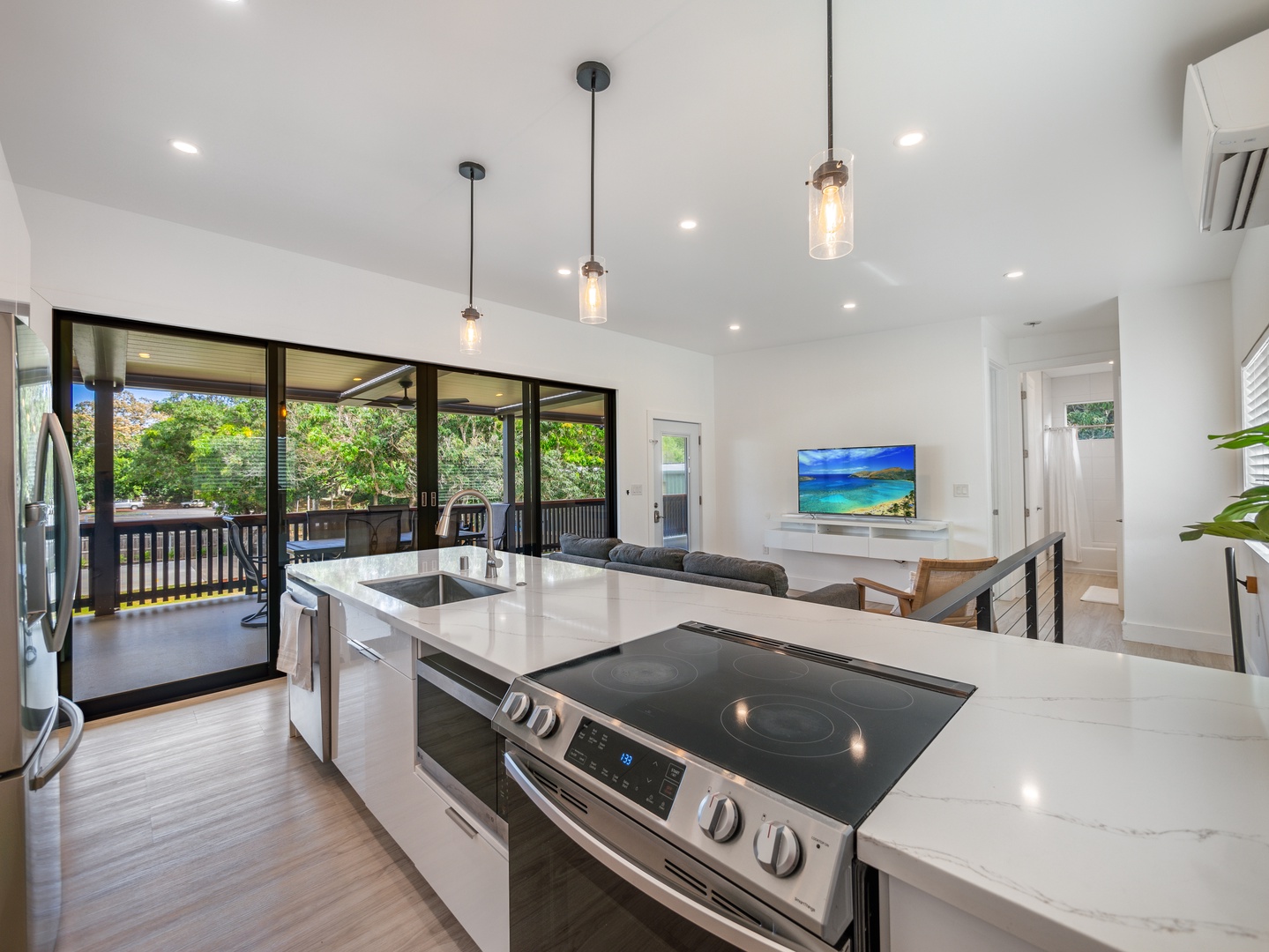 Haleiwa Vacation Rentals, Sunset Beach Island Retreat - This open-concept kitchen is perfect for cooking and entertaining, featuring sleek modern appliances and a spacious island.