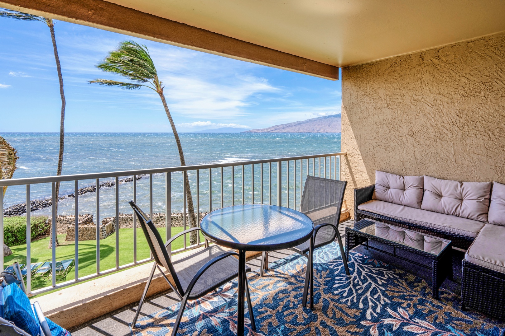 Kihei Vacation Rentals, Menehune Shores 316 - Wind bends the palms outside while the wicker sofa waits for the moment you finally sit still.