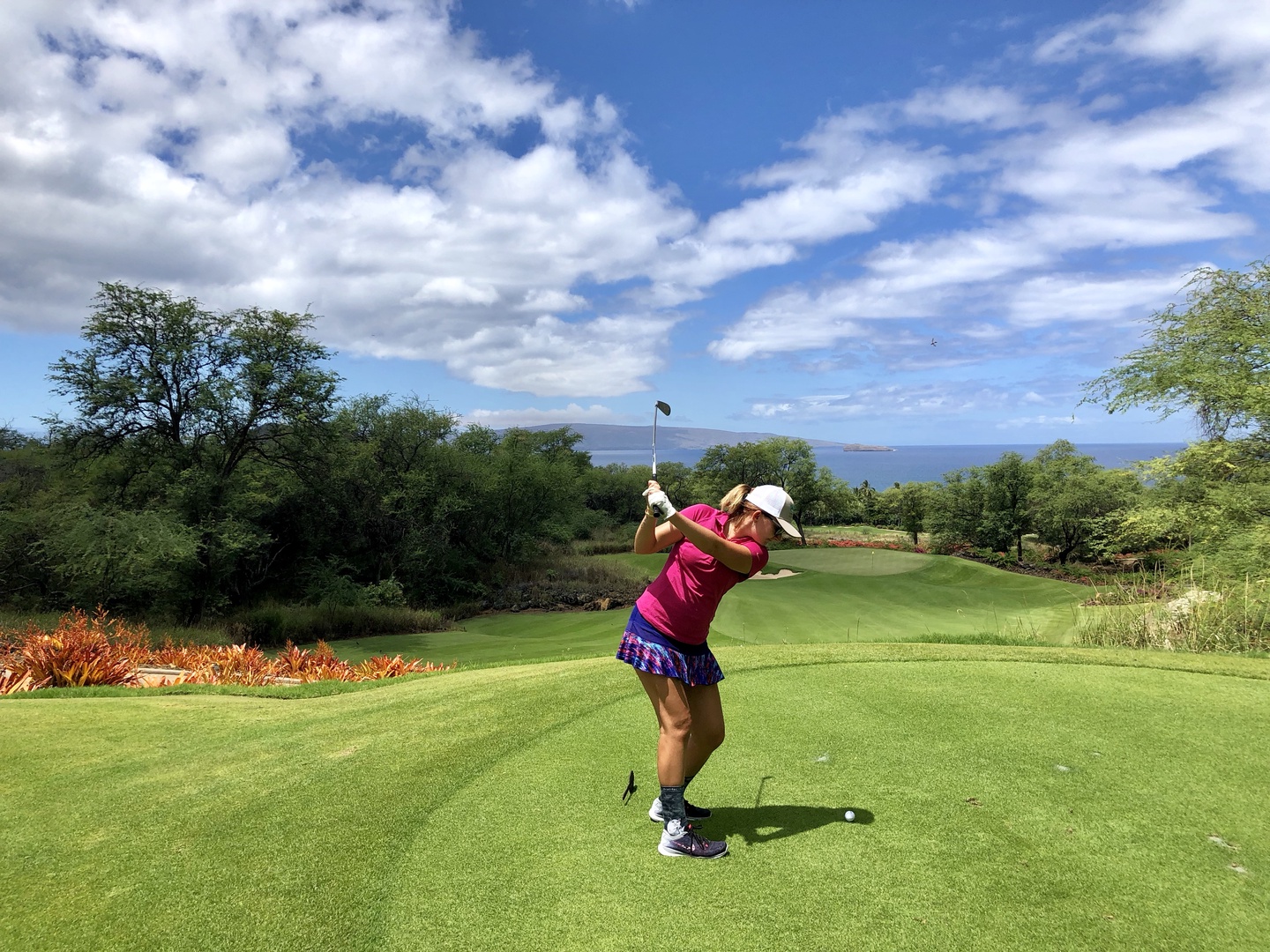 Kihei Vacation Rentals, Wailea Ekolu 1605 - A golfer enjoying a perfect day on the course with scenic views and lush surroundings.