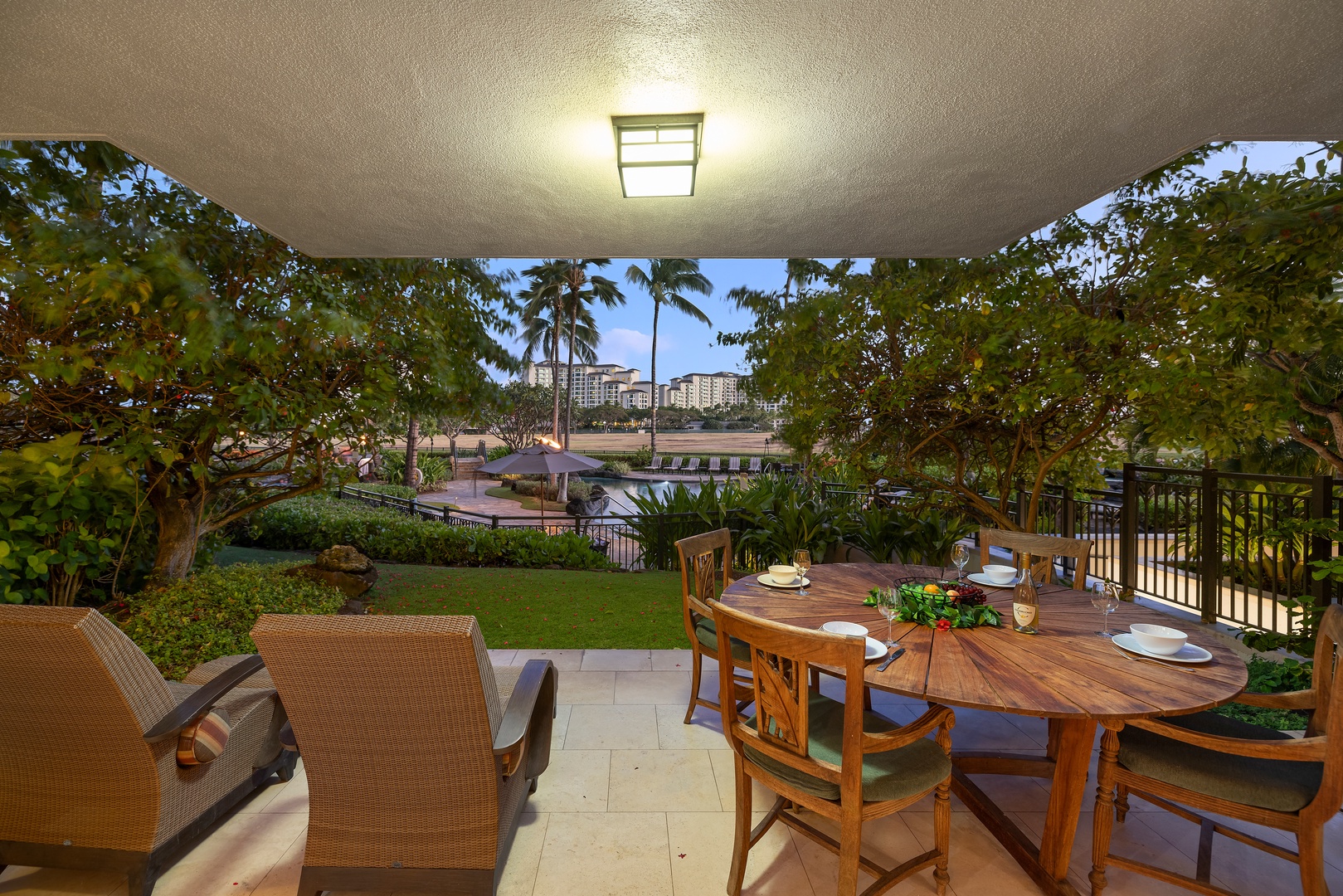 Kapolei Vacation Rentals, Ko Olina Beach Villas B107 - Lanai view with seating and loungers in a tropical paradise.