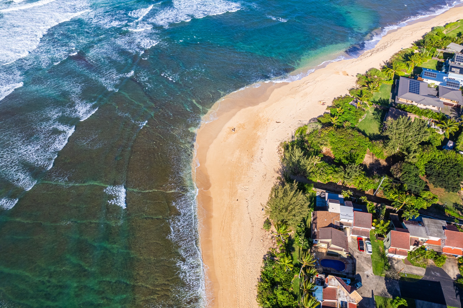 Haleiwa Vacation Rentals, Sunset Point Hawaiian Beachfront** - Aerial shot of the shores.