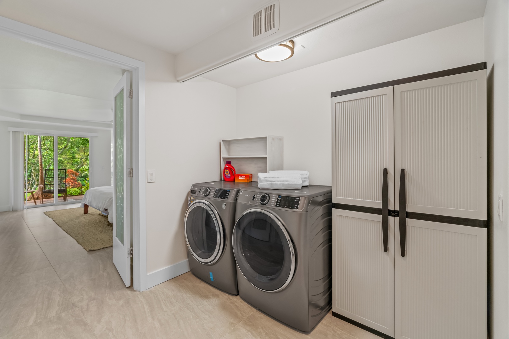 Princeville Vacation Rentals, Mana Wahine - Full laundry room with high-efficiency washer, dryer, and second fridge.