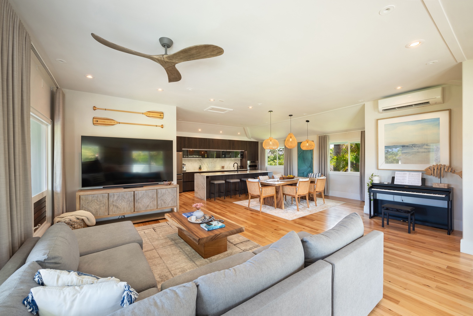 Princeville Vacation Rentals, Hihimanu House - Comfortable living space with a large sectional sofa and warm tones.