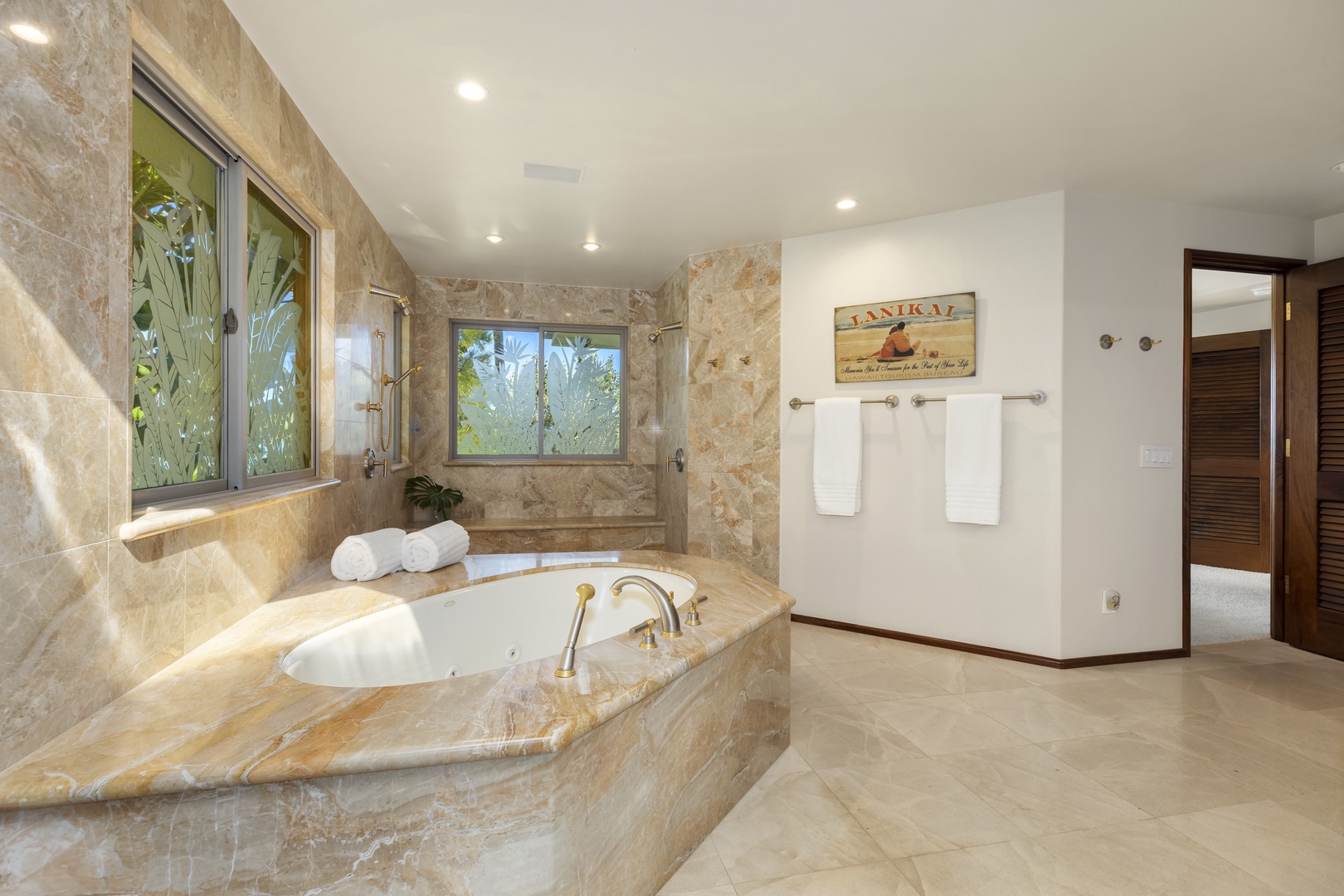 Kailua Vacation Rentals, Mokulua Sunrise - The Primary Bedroom full ensuite bath boasts a jacuzzi tub and walk-in shower with 2 shower heads and a handheld wand