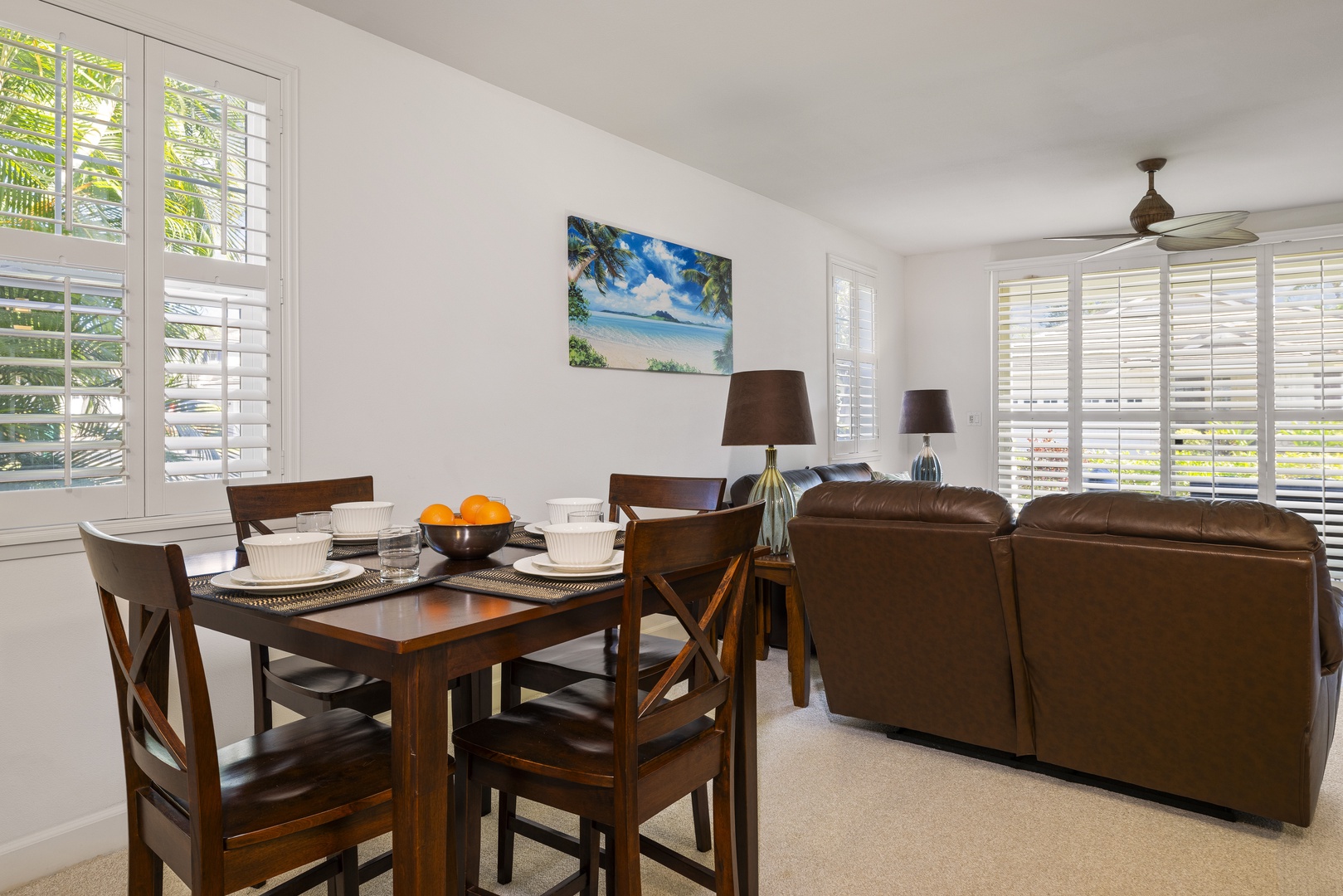 Gather for meals, conversation, or movie nights in the bright living and dining space designed for easy island living.