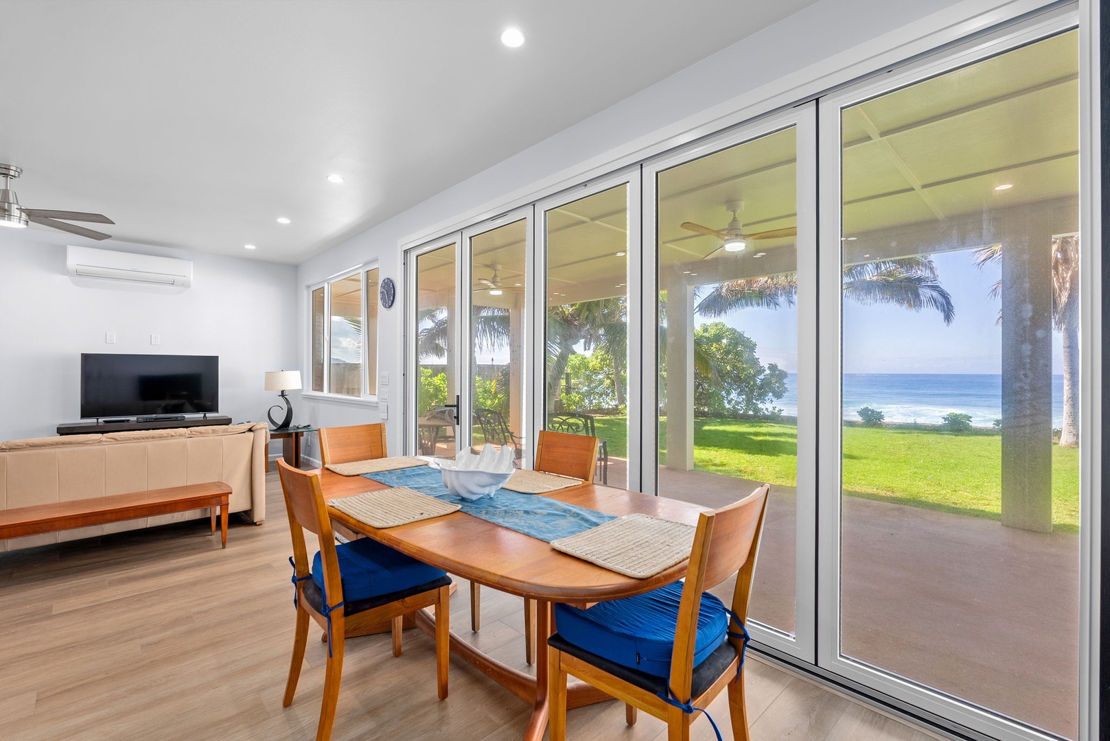 Waianae Vacation Rentals, Oceanfront Luxury Dream Estate - Chic indoor dining with built-in bench and full wall of glass to the tropical backyard.