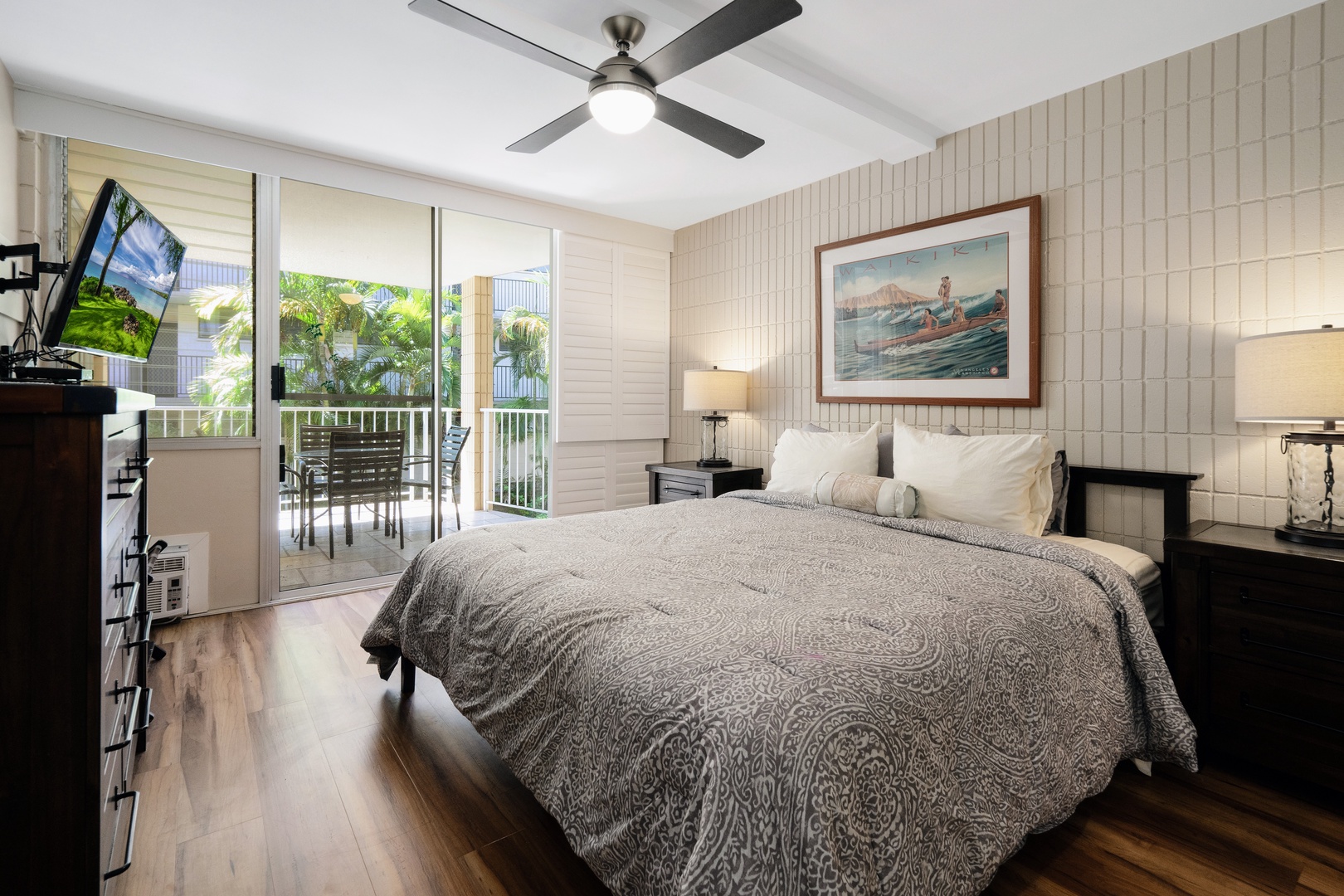 Kihei Vacation Rentals, Haleakala Shores A206 - Sliding glass doors open this bedroom straight onto the lanai, patio table waiting just outside the glass.