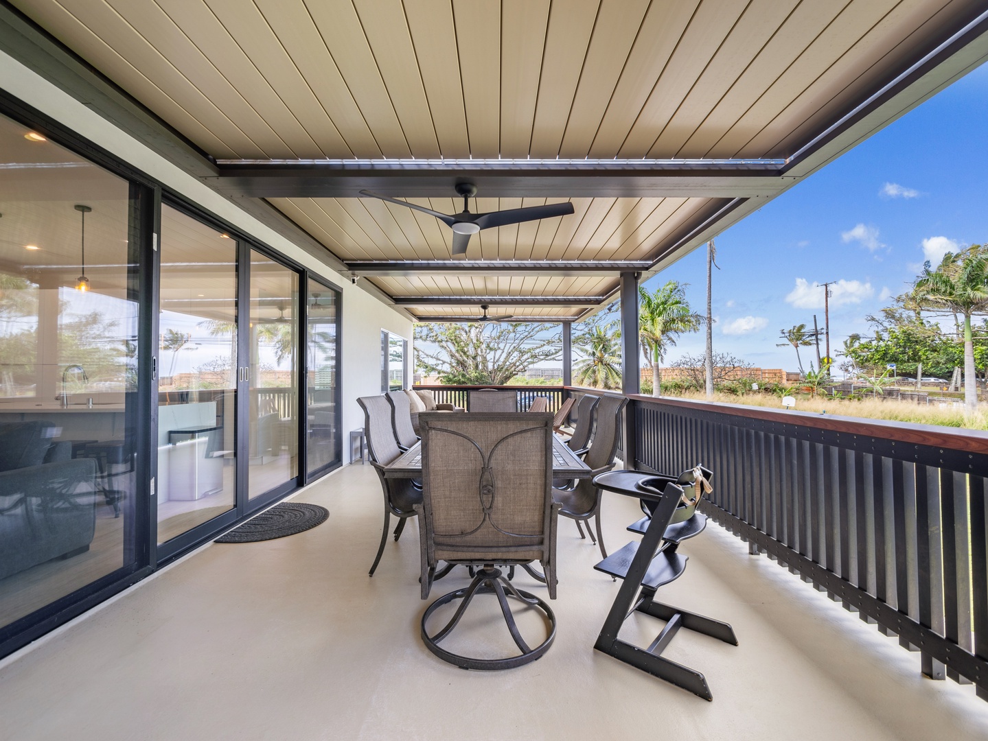 Haleiwa Vacation Rentals, Sunset Beach Island Retreat - This spacious covered lanai offers a perfect spot for al fresco dining or relaxing, with comfortable seating and a ceiling fan to keep you cool.