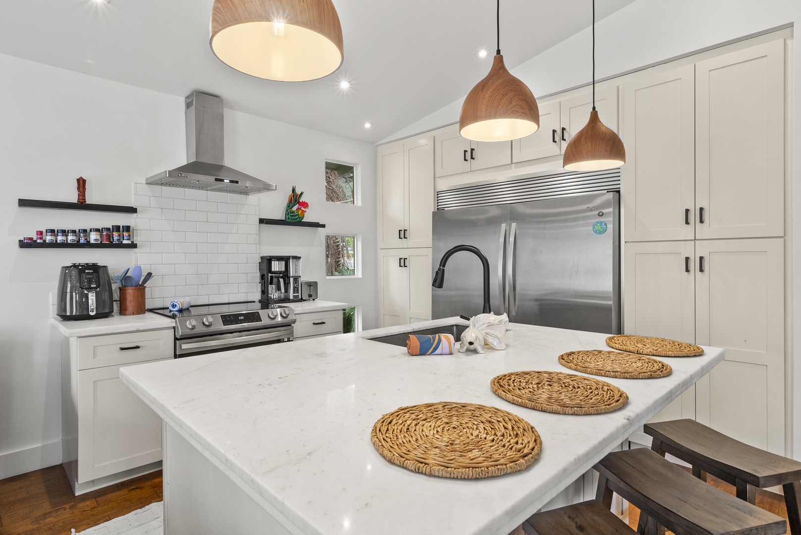 Kaaawa Vacation Rentals, Ka'a'awa Hale - Sleek kitchen with stainless steel appliances and a spacious island, perfect for casual dining.