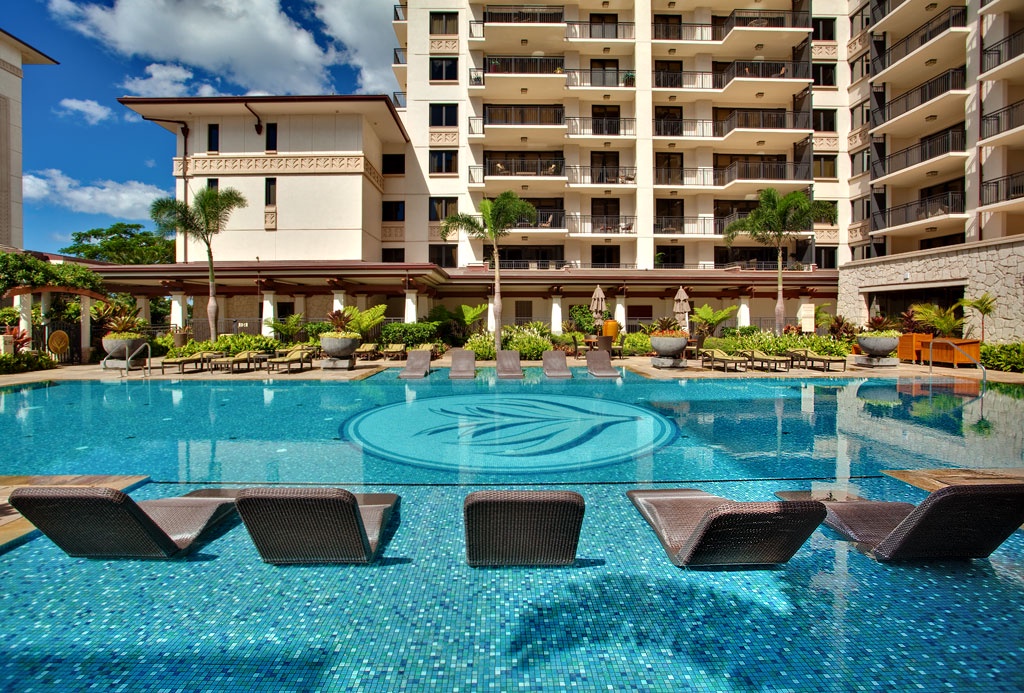 Kapolei Vacation Rentals, Ko Olina Beach Villas B202 - Water loungers at the crystal blue pool.