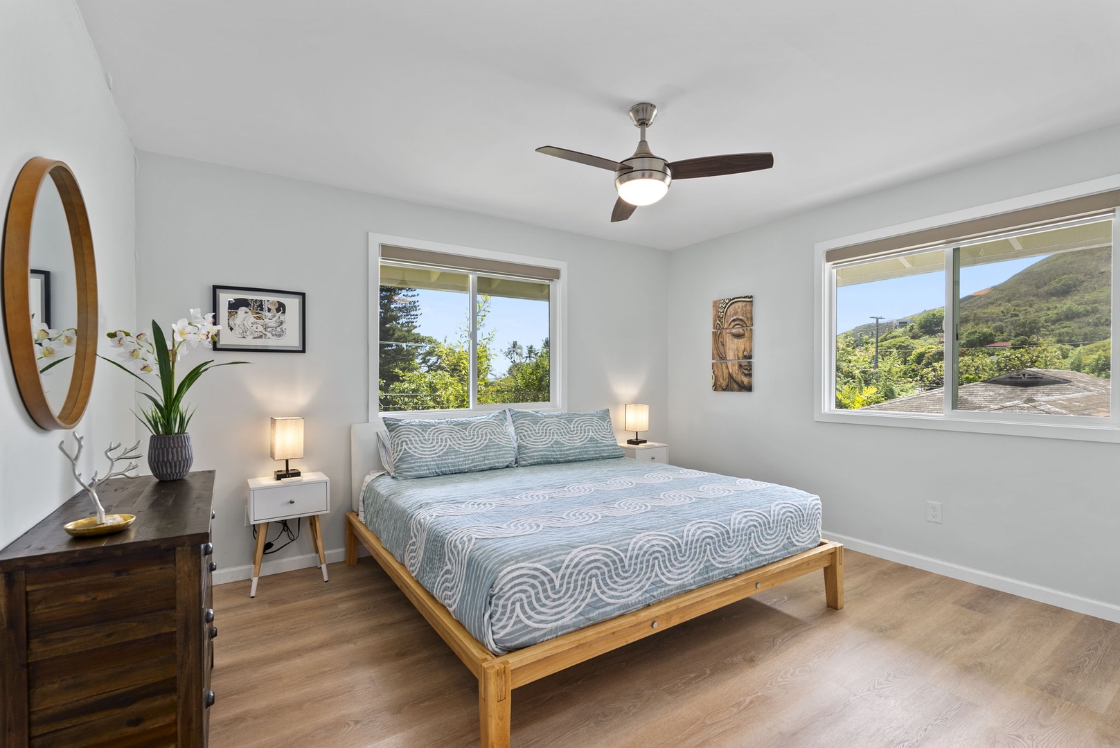 Kailua Vacation Rentals, Hale Alapi'i Lanikai Getaway - Relax in this serene guest bedroom featuring a light and airy decor, framed by nature views from the surrounding windows.