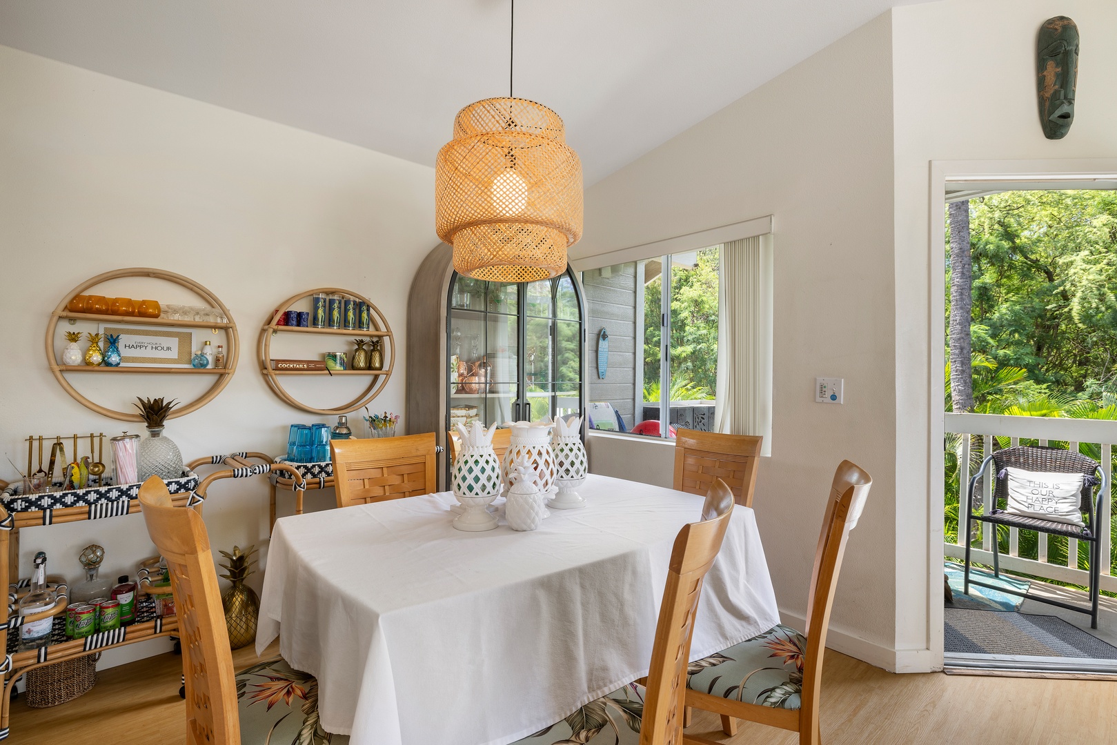 Your bright dining space flows onto a private balcony surrounded by lush greenery, creating the perfect spot for morning coffee or evening meals.