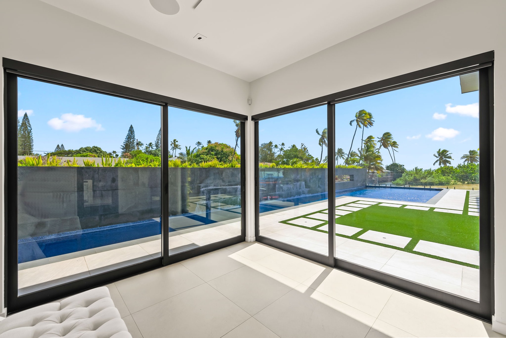 Honolulu Vacation Rentals, Ocean Villa Emilie - Slide open the glass doors and start your morning with views of lush lawns and the inviting lap pool just steps away.