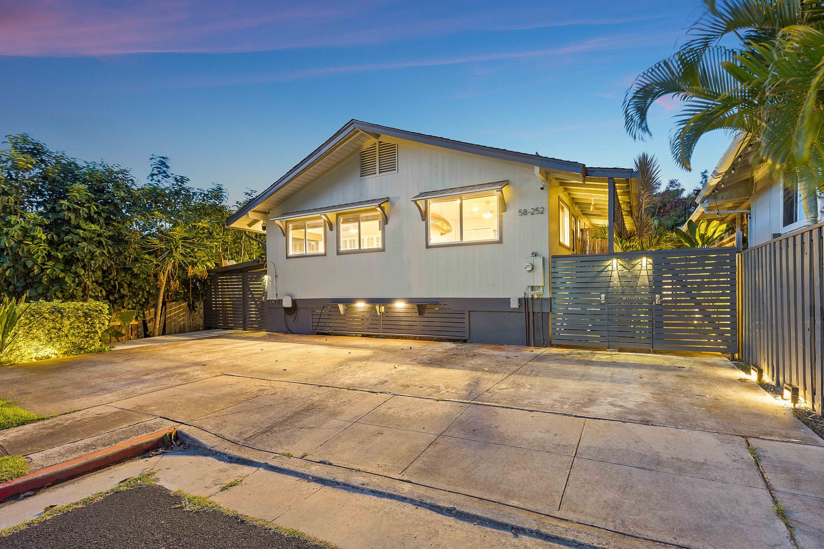 Haleiwa Vacation Rentals, Velzey Villa (3B Vacation Home) - Striking front exterior at twilight, showcasing the villa’s welcoming glow.