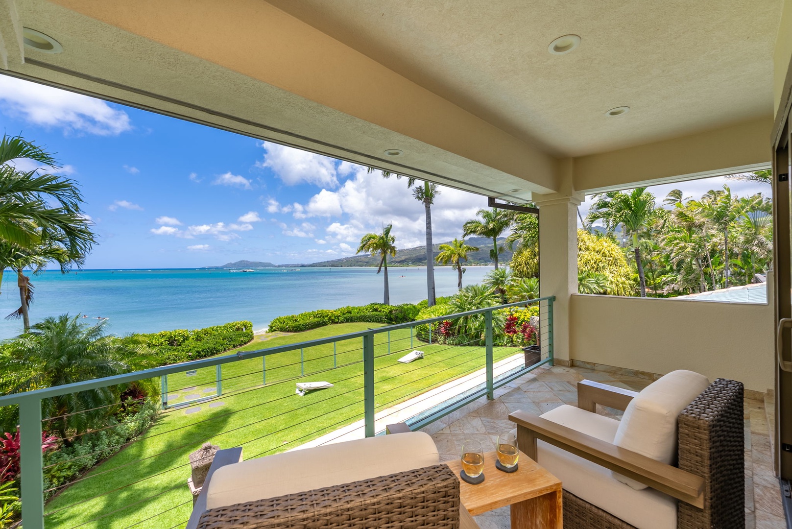 Honolulu Vacation Rentals, Maunalua Estate - Ocean breezes and swaying palms frame this open-air lounge with sweeping coastal views.