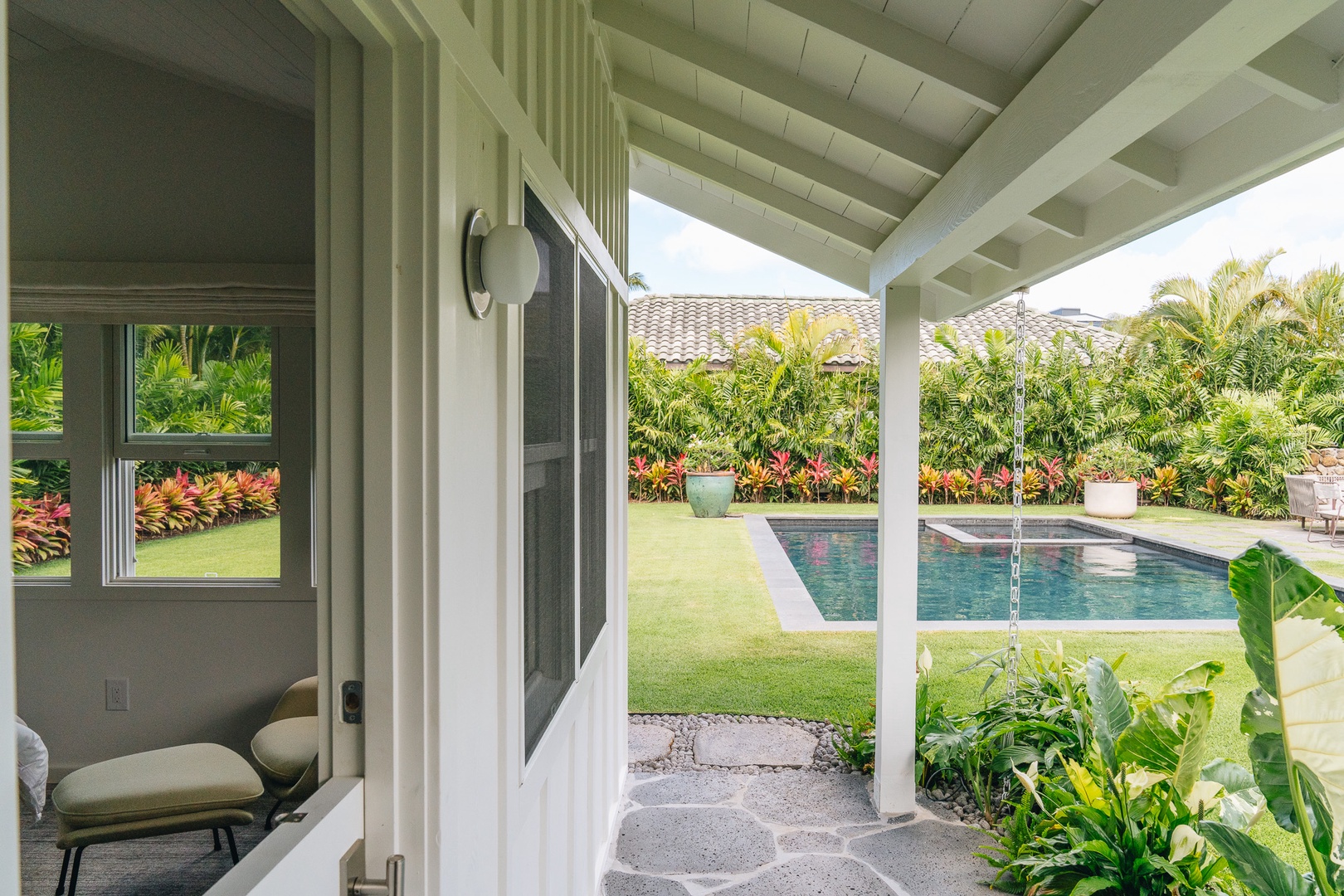 Honolulu Vacation Rentals, Surfside Bungalow** - The covered lanai opens to tropical gardens and the private pool beyond.