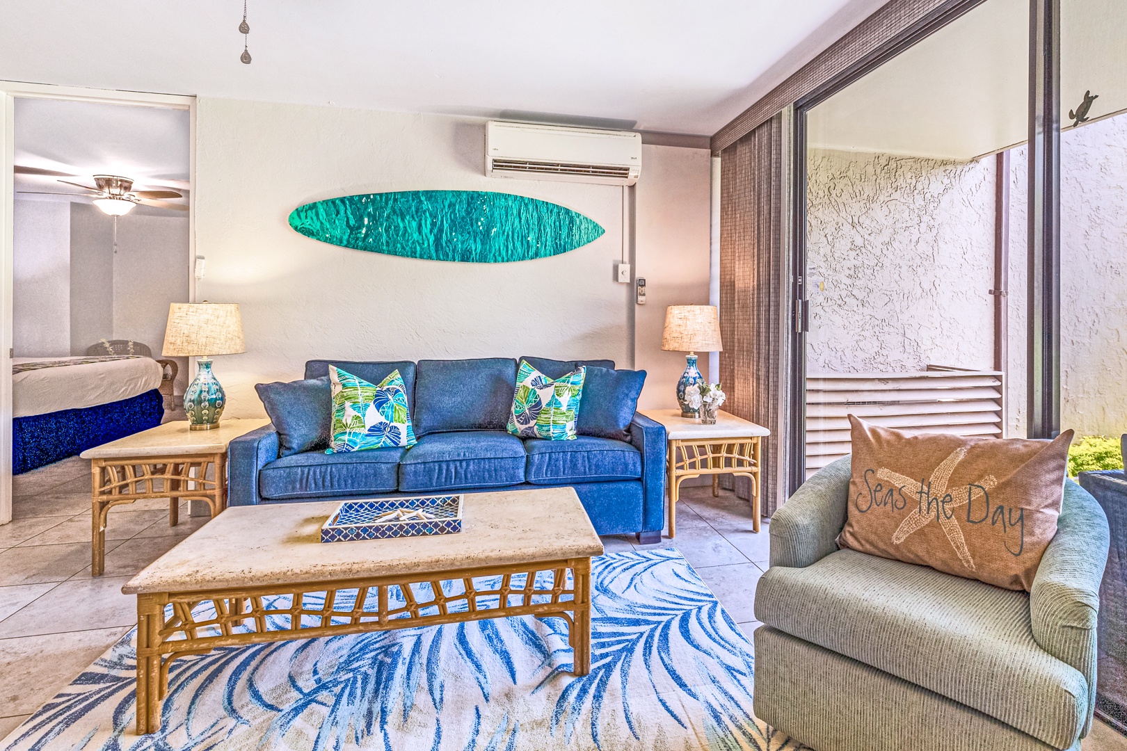 Lahaina Vacation Rentals, Papakea K-105 - The cozy living area features a vibrant coastal design with comfortable seating, perfect for unwinding, and direct access to the lanai.