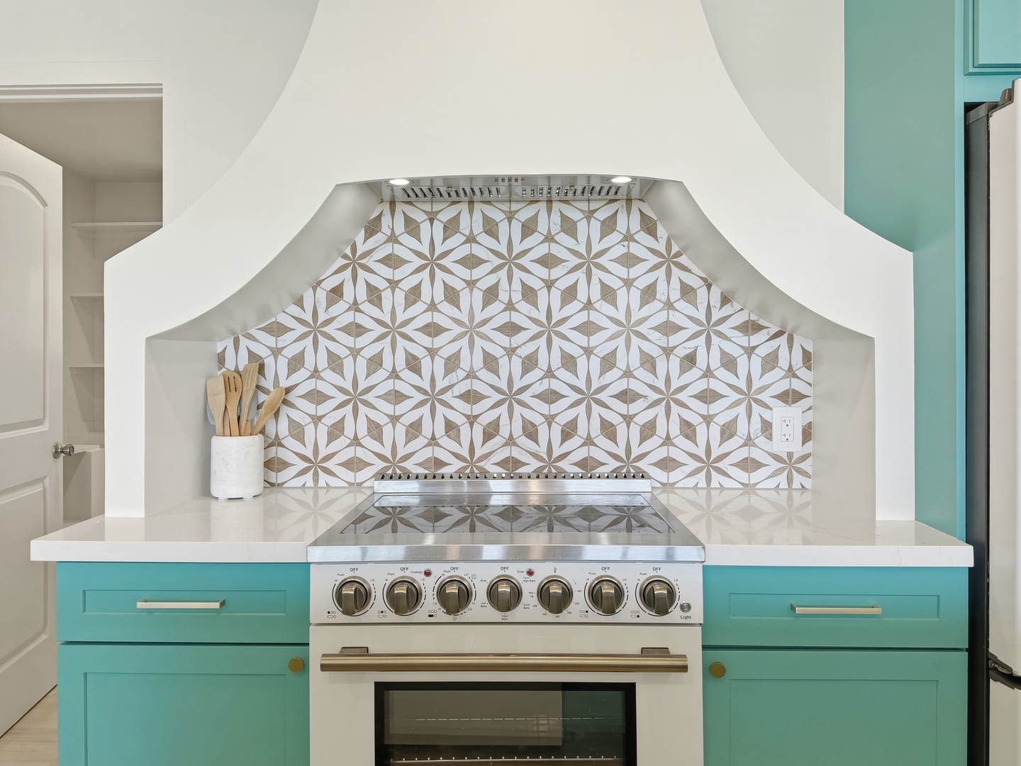 Kailua Vacation Rentals, Kai Nalu - Your chef dreams come alive in this stunning kitchen featuring a geometric tile backsplash and turquoise cabinetry.