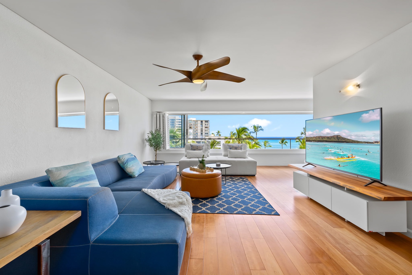 Honolulu Vacation Rentals, Colony Surf Retreat - Stylish and spacious living area with a plush sectional, ceiling fan, and unbeatable ocean views just steps away.