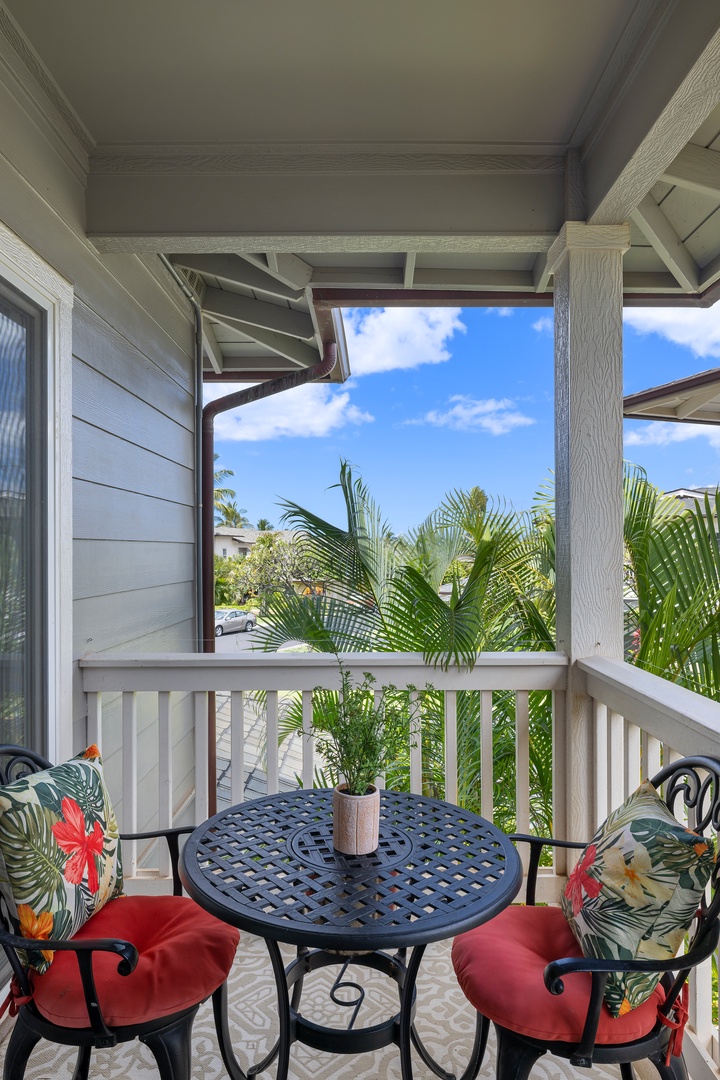 Kapolei Vacation Rentals, Coconut Plantation 1190-1 - A bistro table for two surrounded by lush greenery.