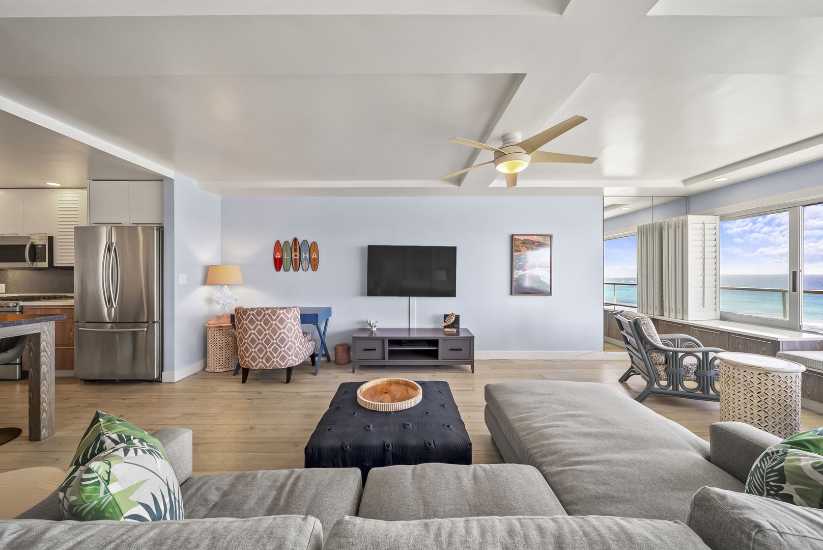 Honolulu Vacation Rentals, Kaimana Tides at Colony Surf - Unwind in your spacious living room with stunning ocean views, modern kitchen, and tropical touches that make every moment feel like paradise.