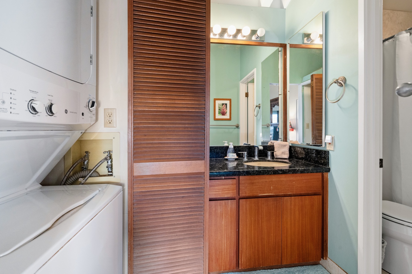 Kihei Vacation Rentals, Wailea Ekolu 204 - A stacked washer and dryer share this alcove with the vanity, so beach towels can go straight into a load instead of home in a suitcase.