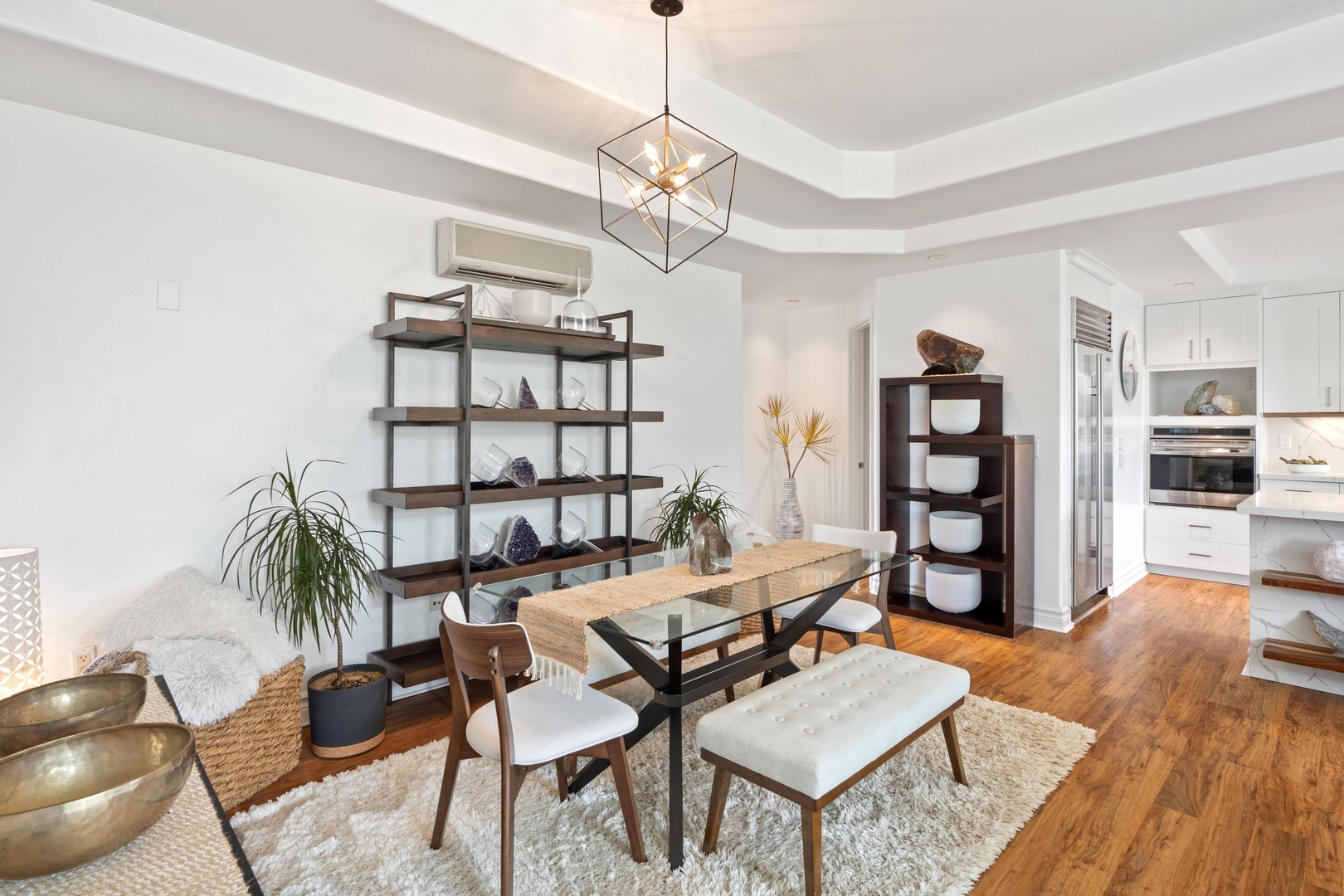 Princeville Vacation Rentals, Tropical Elegance - Experience elegance in a dining area illuminated by a modern geometric pendant light.