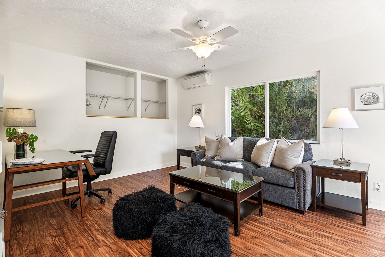 Kailua-Kona Vacation Rentals, Honu Hale - Relax in your stylish office space with cozy sleeper sofa, workspace, and tropical garden views through large windows.