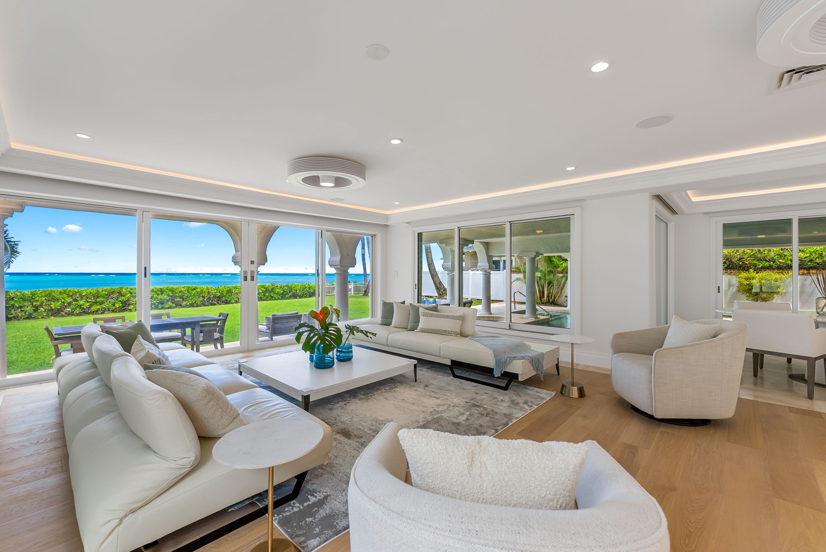 Kailua Vacation Rentals, Lanikai Sunrise Estate - Modern seating area with plush furnishings and glass sliders that open to the lawn and ocean beyond.