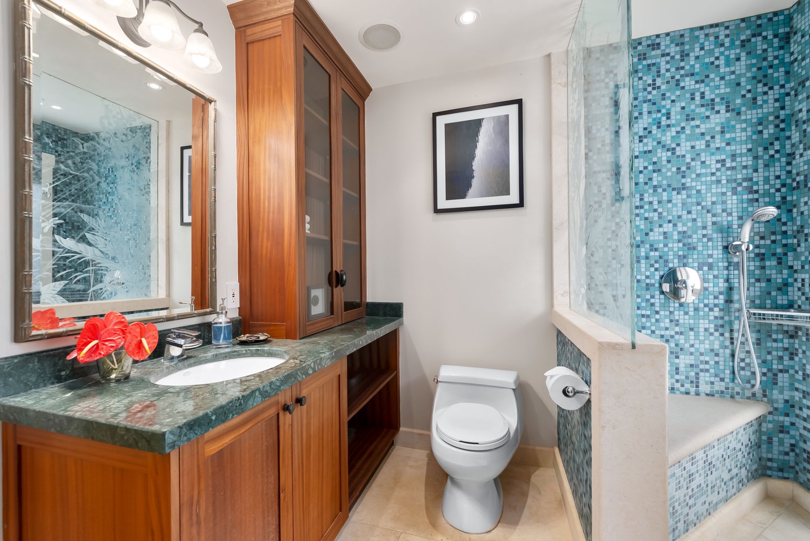 Kailua Vacation Rentals, Leaf House - Step into your private spa-like retreat with stunning turquoise mosaic tilework, a spacious walk-in shower, and elegant wood cabinetry. Fresh flowers and thoughtful touches make every moment feel indulgent.