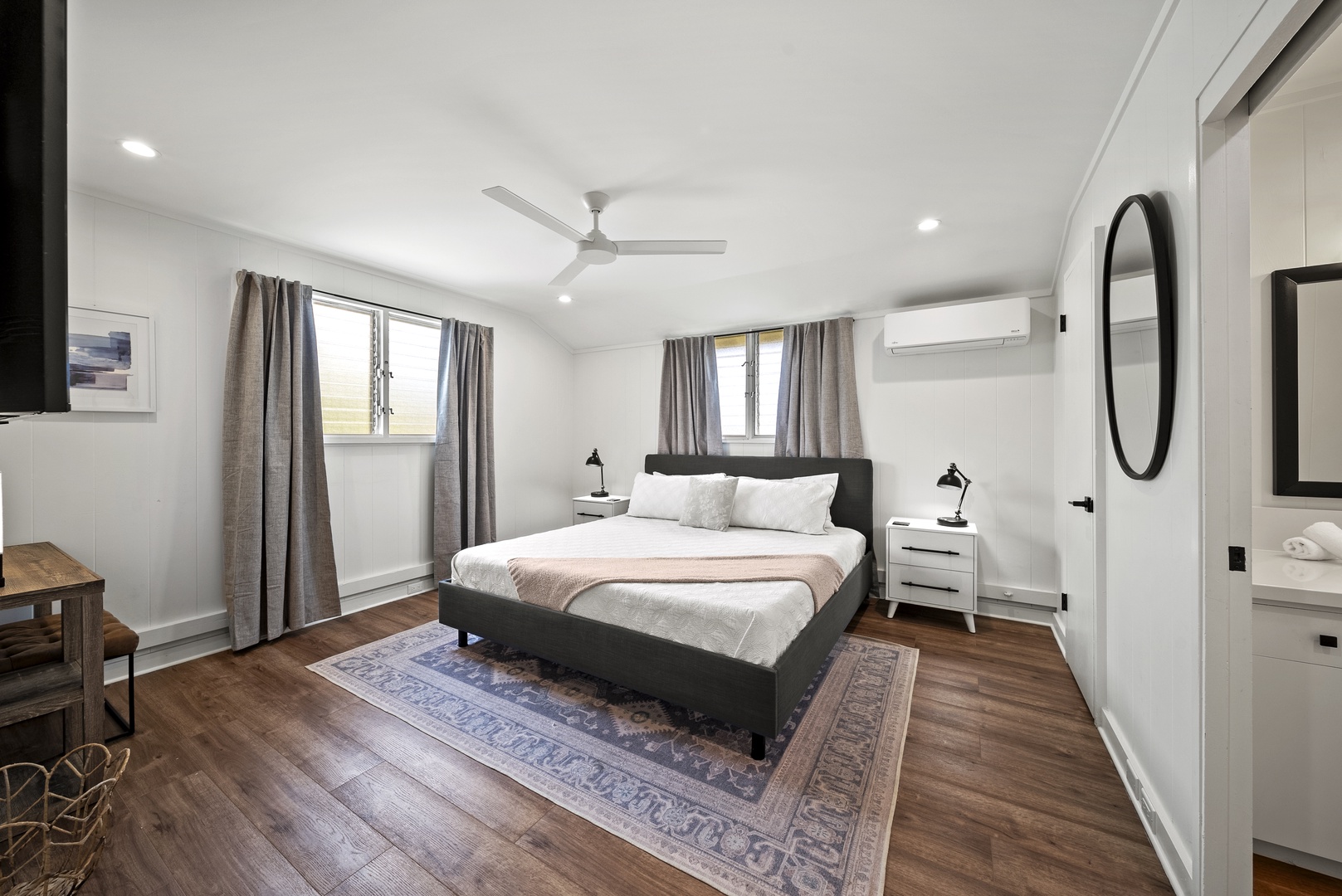 Honolulu Vacation Rentals, Honolulu Beachfront Retreat - Minimalist suite with a king-sized bed, serene design, and large windows for natural light and breezy comfort.