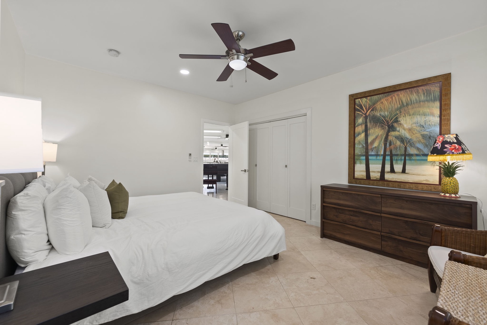 Honolulu Vacation Rentals, Kahala Lani - Spacious guest room with ceiling fan and elegant island-inspired design.