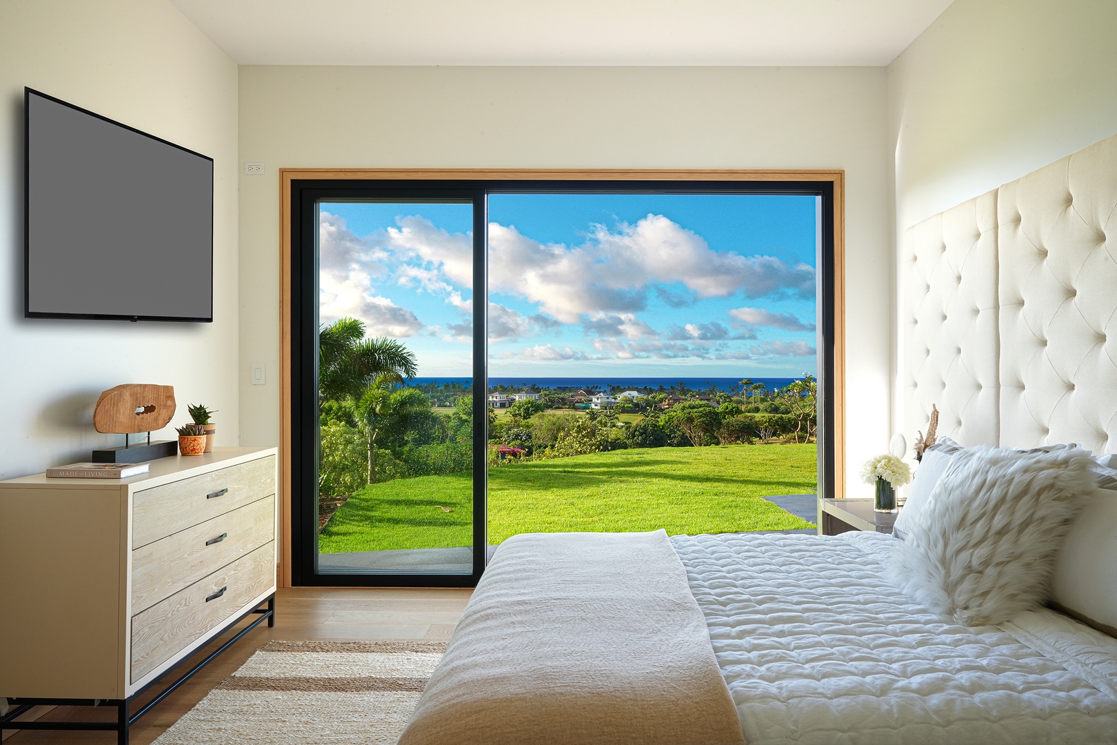 Koloa Vacation Rentals, Hale Keaka at Kukui'ula - Awake in the guest bedroom 1 to a picturesque landscape framed by expansive sliding doors, inviting the beauty of the outdoors into your peaceful haven.