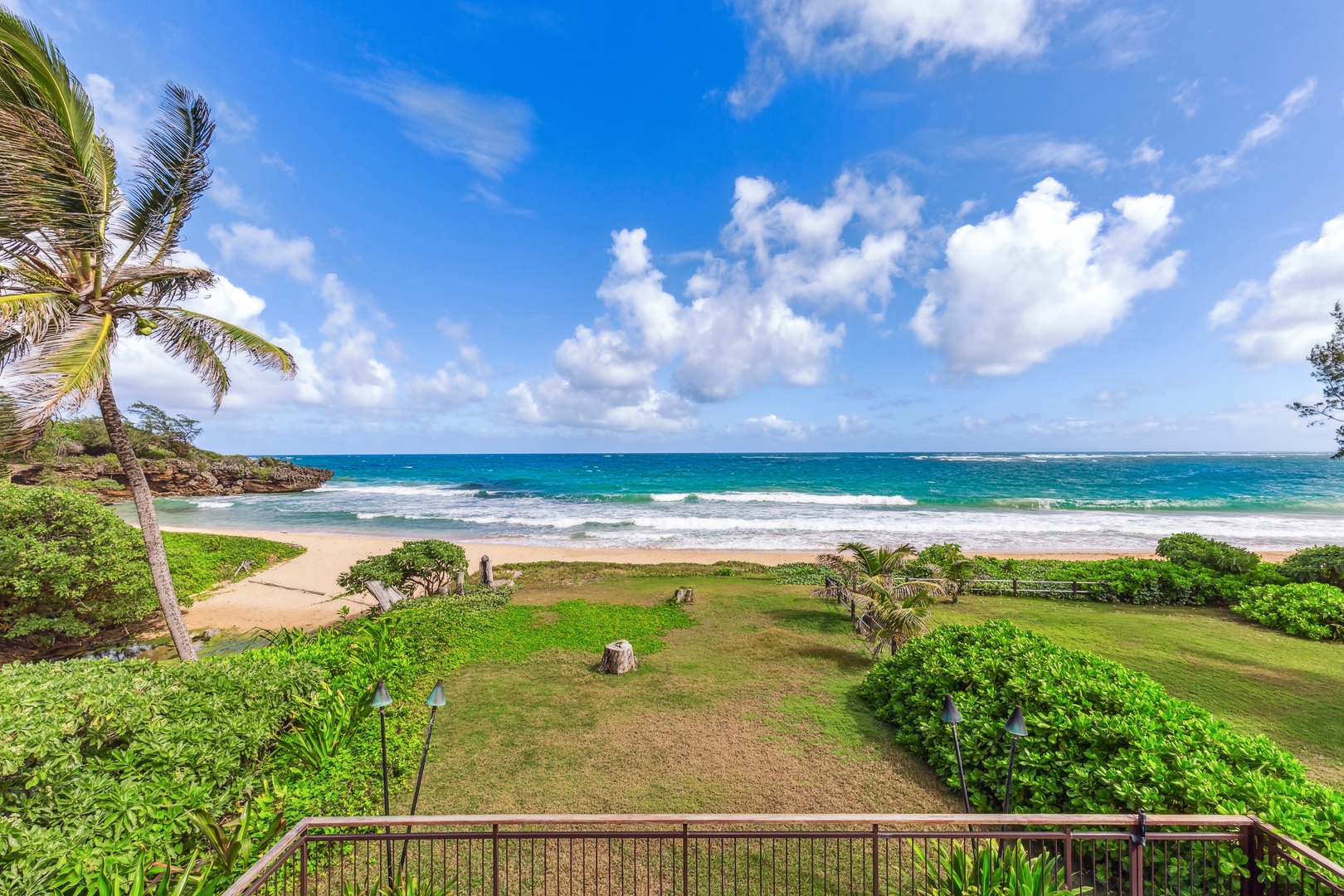 Laie Vacation Rentals, Majestic Mahakea Oceanfront Oasis - Lush green spaces and a winding path leading to the private beach.