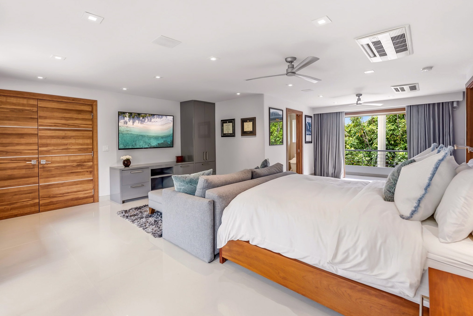 Honolulu Vacation Rentals, Diamond Head Beachfront Estate - Unwind in your serene bedroom suite with crisp linens, modern comforts, and lush garden views that invite natural light and tropical tranquility into your personal retreat.