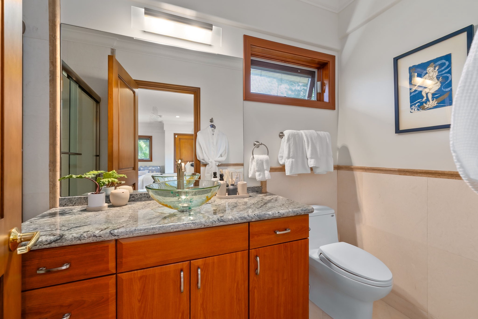 Honolulu Vacation Rentals, Maunalua Estate - Granite countertops, warm wood cabinetry, and elegant finishes create a bright, welcoming bathroom space.
