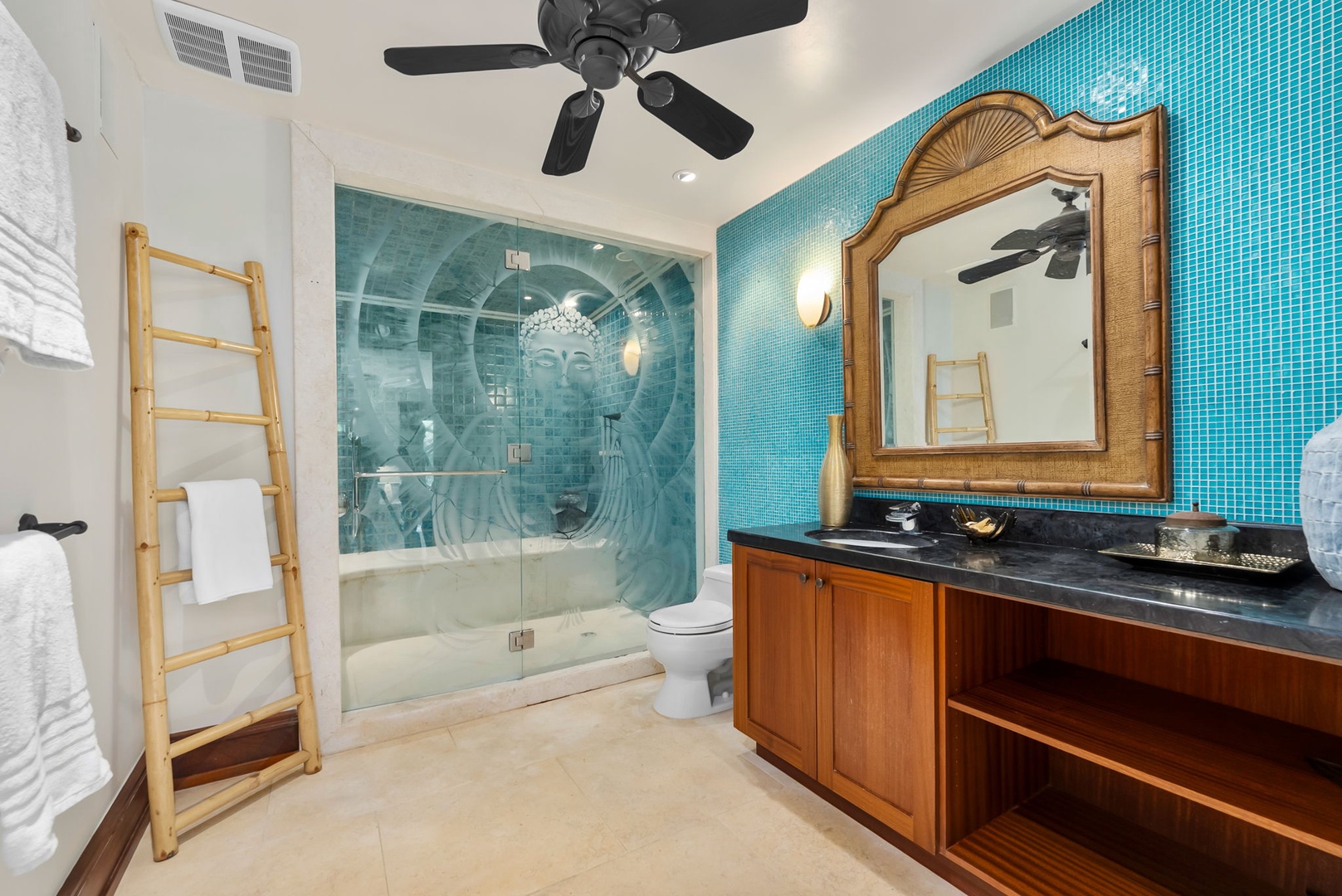 Kailua Vacation Rentals, Leaf House - Refresh in your private spa-like bathroom with vibrant turquoise tile, a spacious walk-in shower, and tropical-inspired wood accents. Fluffy towels await on a charming ladder rack.