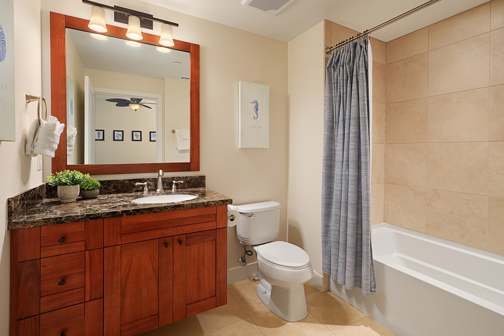 Koloa Vacation Rentals, Pili Mai 6J - Refresh in your private bathroom featuring elegant granite countertops, warm wood cabinetry, and a relaxing tub-shower combo for unwinding after your adventures.