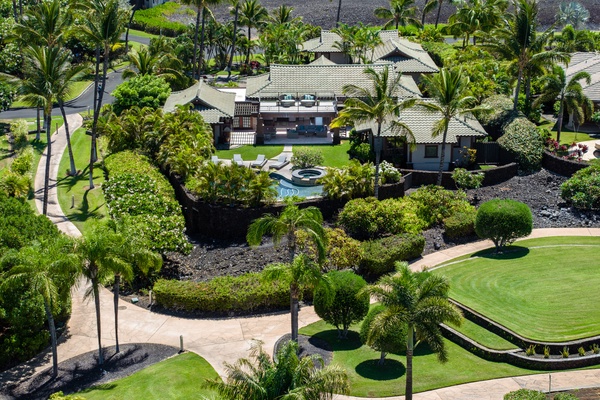 Kamuela Vacation Rentals, Canoe House & Beach Walker at Champion Ridge - Private tropical estate with a pool, surrounded by lush greenery and a scenic landscape.
