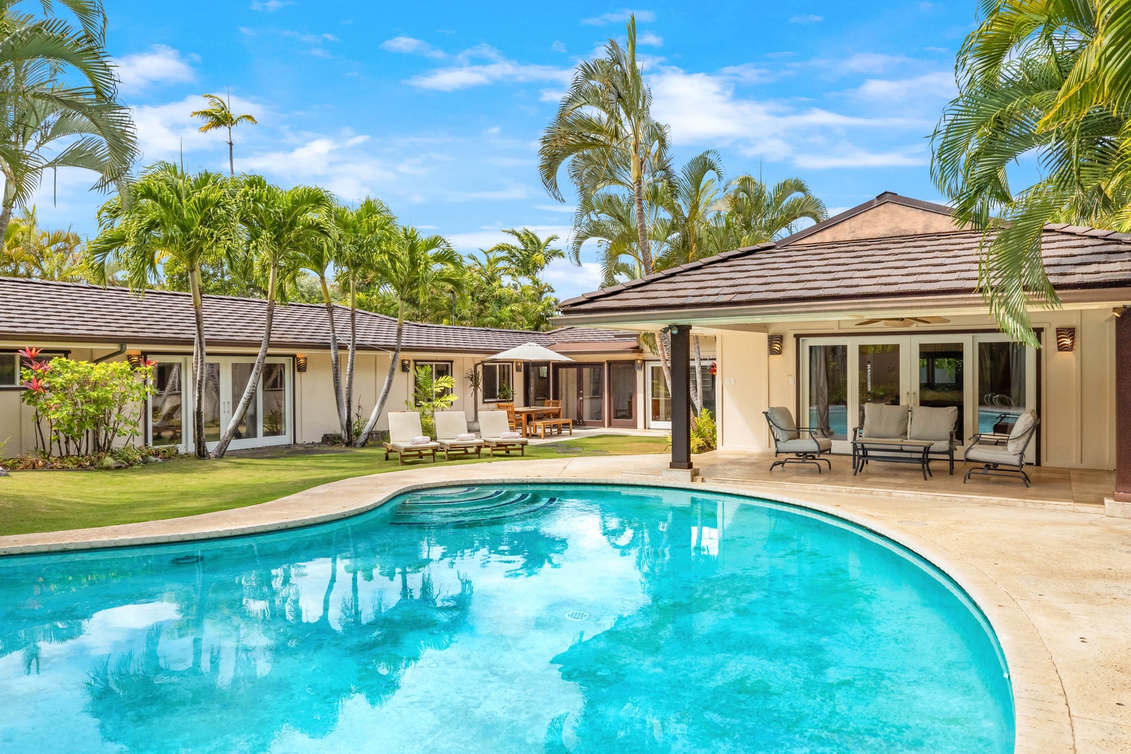 Honolulu Vacation Rentals, Kahala Breeze - Inviting resort-style pool with crystal-clear waters, framed by a beautifully landscaped garden—your luxury retreat at home.